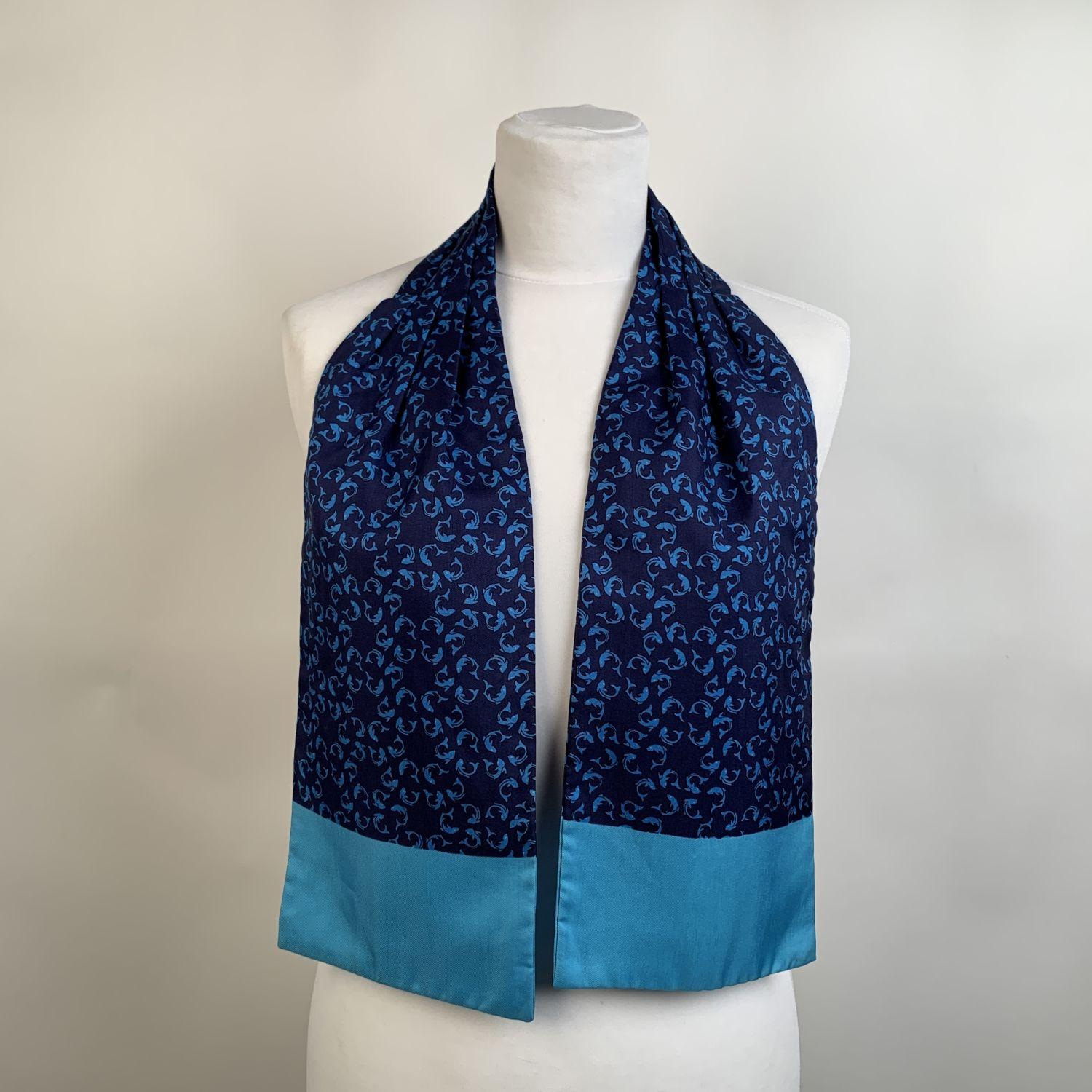 Sophisticated ascot scarf by HERMES, featuring turquoise fish pattern on blue background. Pleated,stitched center section. Both suitable for man or woman can be worn in many different ways: as an ascot, at neck, in hair, as a belt or tied on your