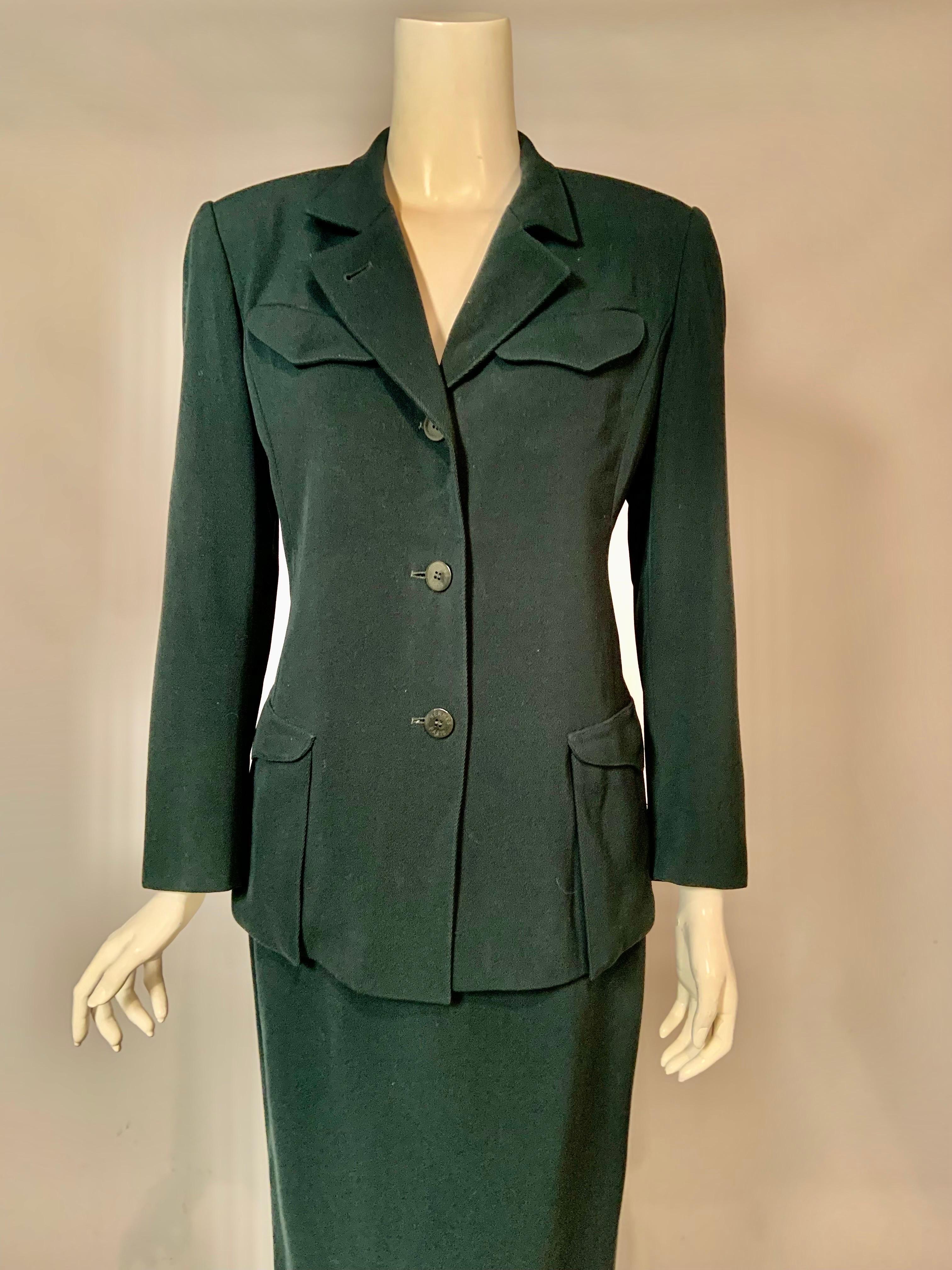 This is a great vintage Hermes bottle green wool suit jacket and midi skirt suit from the 1980's, and a wonderful example of the 80's does 40's.  The jacket has notched lapels and two breast and two hip pockets.  There are three Hermes logo buttons