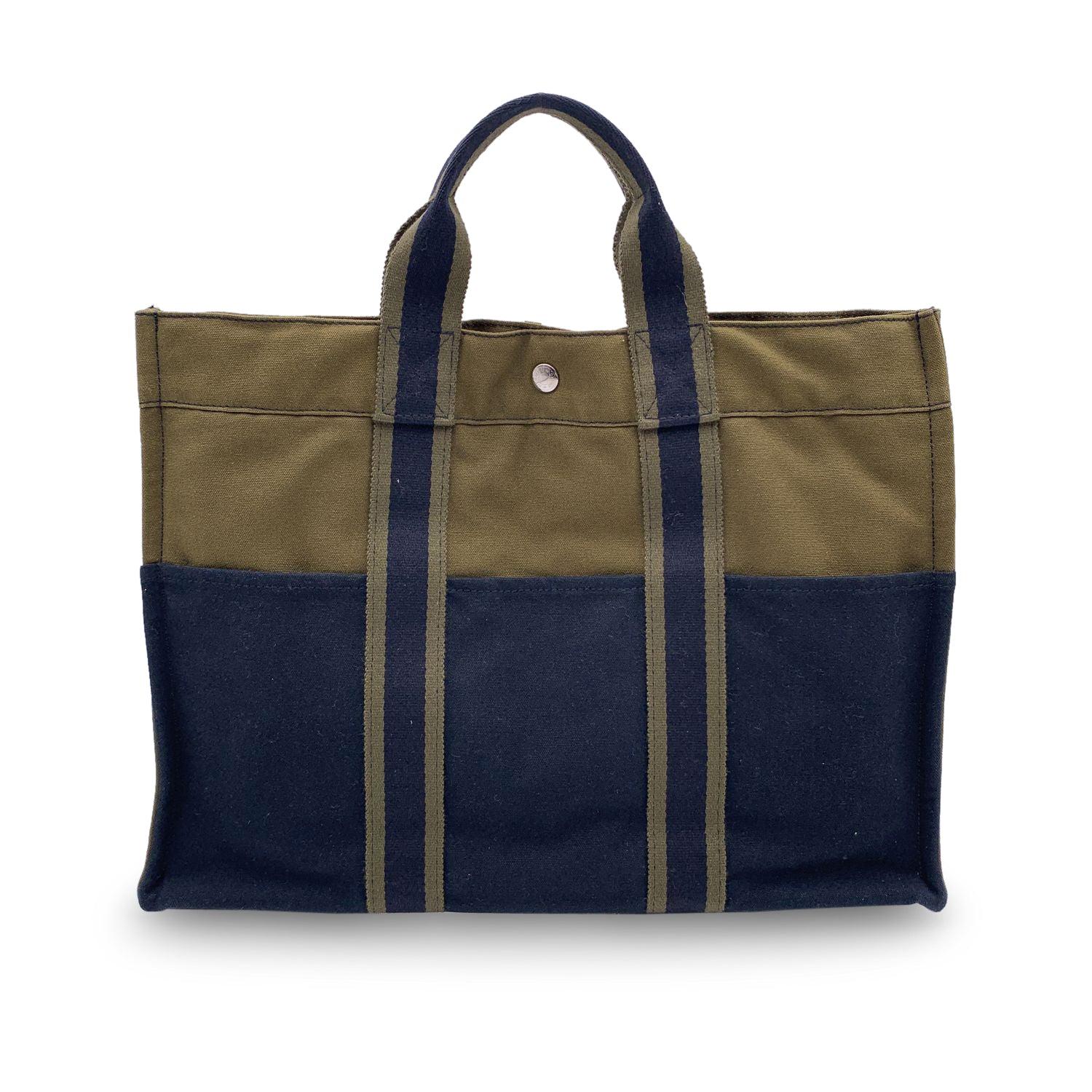 Hermes Paris Vintage green and blue cotton canvas tote, Fourre Tout MM. Made in France. Green and blue stripes. 100% Cotton. 3 front pockets on the front and 3 pockets on the back. It has snaps (buttons) on both ends for expansion. Durable canvas