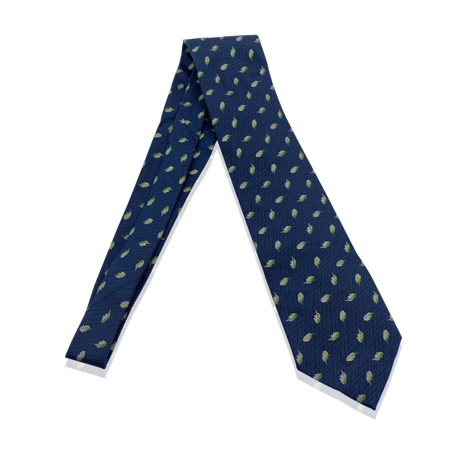 Elegant Hermes Neck Tie in blue teal color with an allover leaves pattern. Composition: 100% Silk. Hermes composition tag attached. Made in France. Total length: 58.5 inches - 148.5 cm. Max width: 3.5 inches - 8.9 cm Details MATERIAL: Silk COLOR: