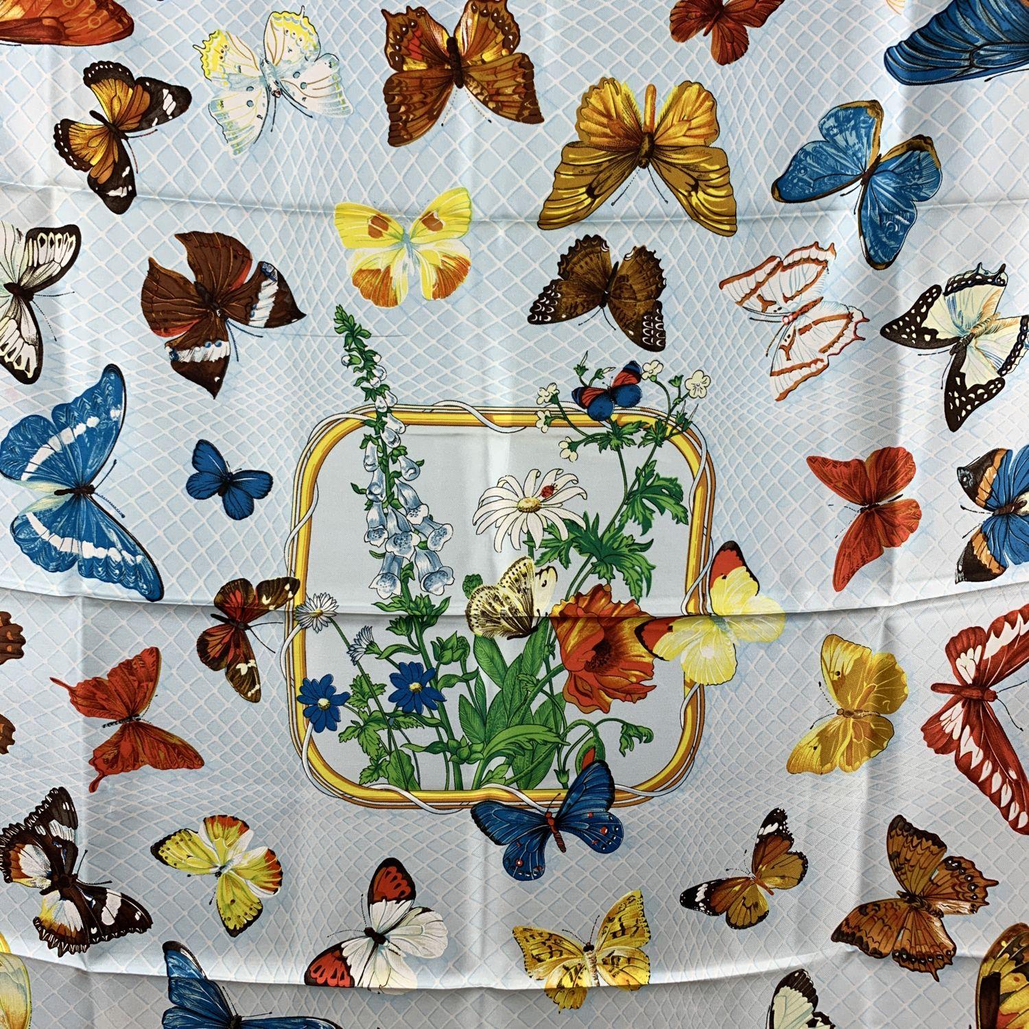 Vintage HERMES Silk scarf named 'Farandole', created by artist Caty Latham, and first issued in 1985. It was re-issued in 1990 and in 2006. Beautiful butterflies design. Red border. 100% Silk. Hand rolled edges. Approx measurements: 35 x 35 inches -