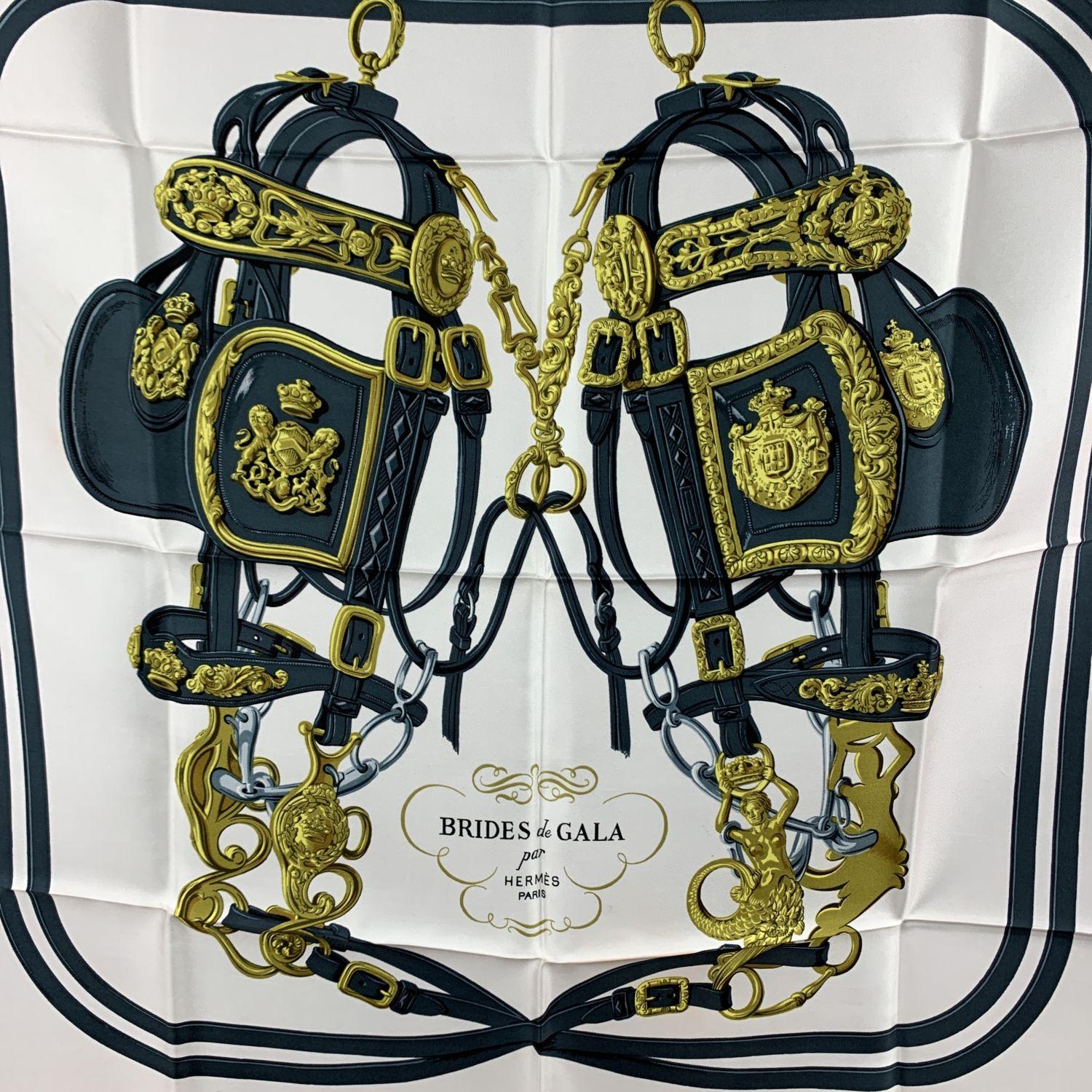 HERMES scarf 'Brides de Gala' by Hugo Grygkar and originally issued in 1957. It is a truly classics of Hermes maison and it is issued constantly. This design depicts two bridles decorated with the emblazoned fastenings that adorned horse-drawn