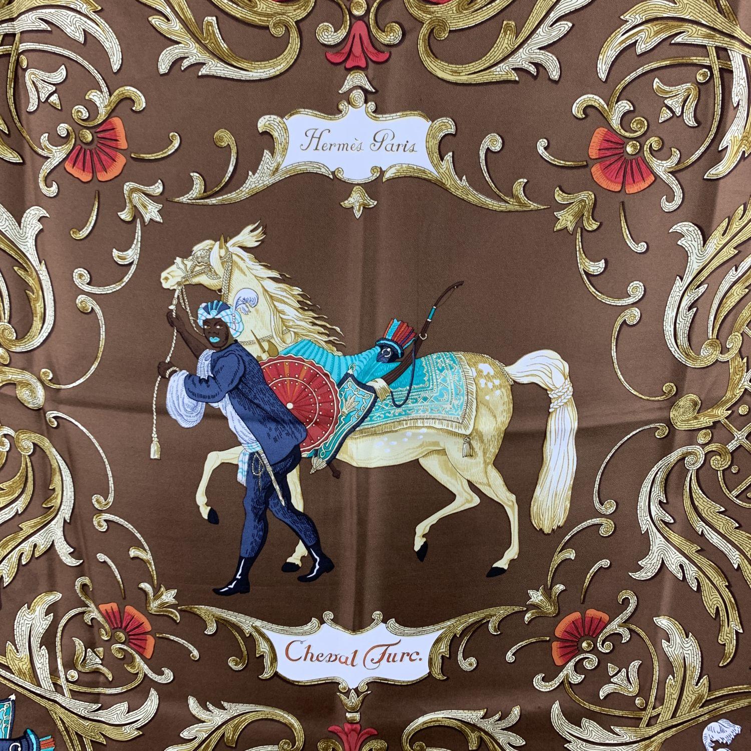Vintage Hermes silk scarf 'Cheval Turc' scarf designed by Christiane Vauzelles and first issued in 1969. It features an equestrian theme scarf features a man with a turban leading a horse with a brown background. Features hand rolled edges. Approx.
