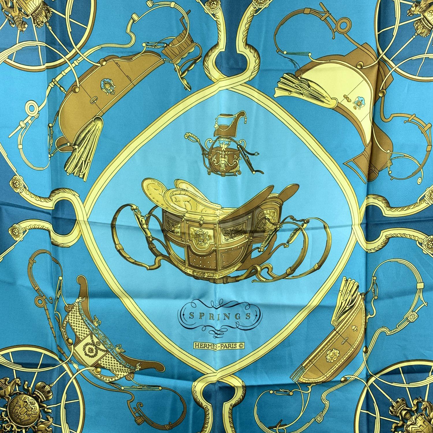 Hermes Paris Vintage Silk Scarf 'Springs' . It depicts in its center the phaeton carriage belonging to Napoleon I's son. Artist :Philippe Ledoux. First Issue : 1974. Main colors are turquoise, teal and yellow gold. Hand rolled hem. Fabric /