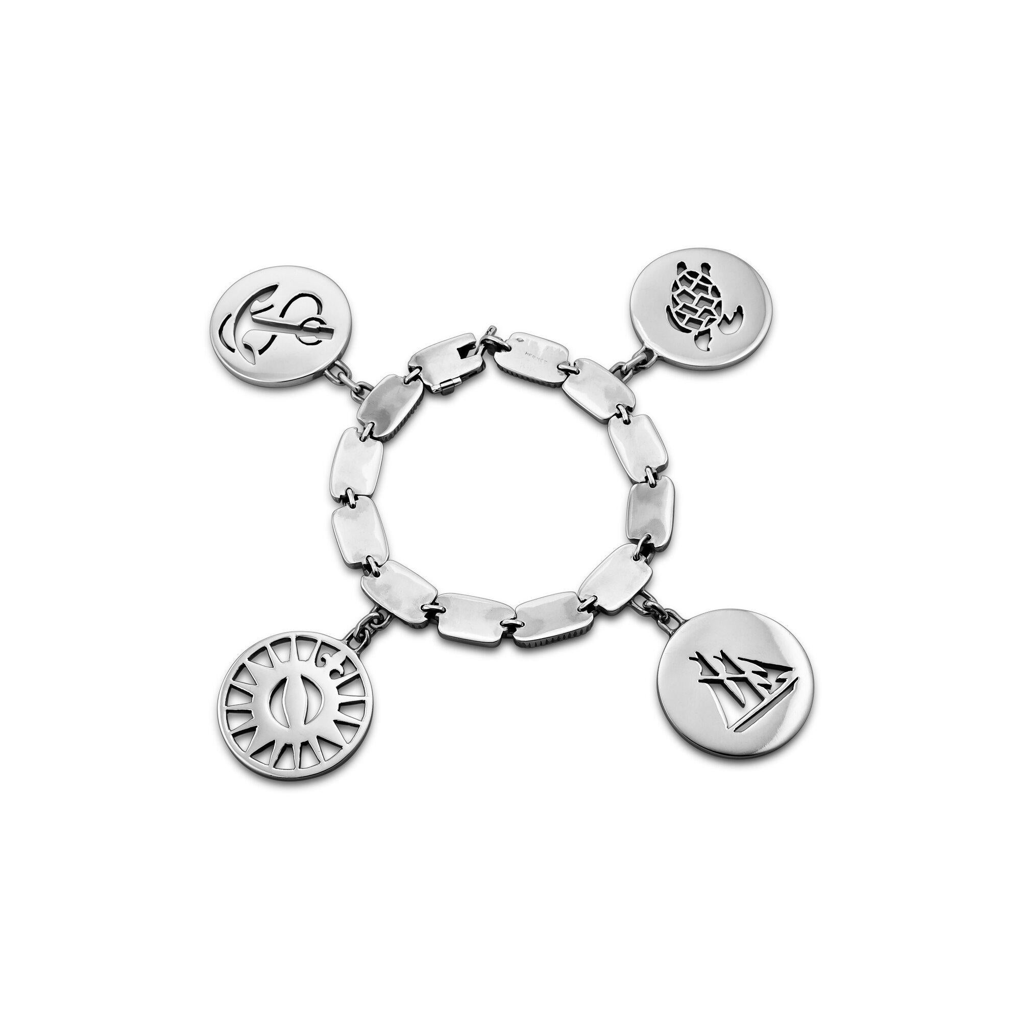It will always be 'smooth sailing' when wearing this incredible vintage Hermes Paris four charm Nautical link bracelet.  With an anchor, a compass, a sailboat, and a sea turtle pierced disc charm hanging from a flat link/rope chain bracelet, you