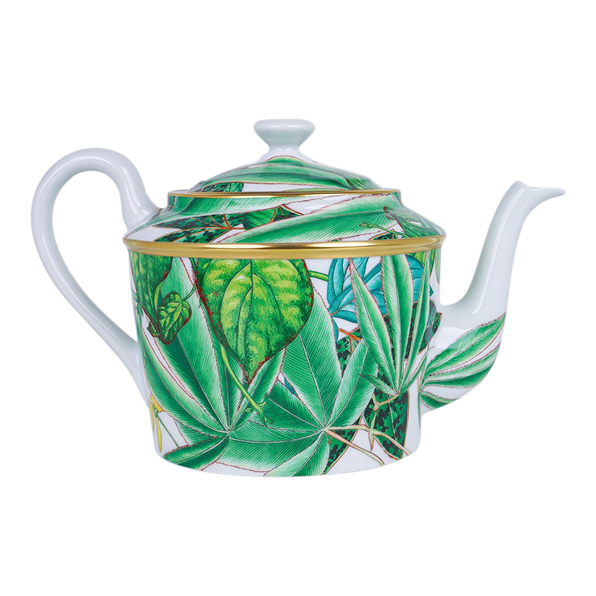 Mightychic offers an Hermes Teapot featured in the classic Hermes Passifolia pattern.
A beautiful hommage to the peace and power of flora.
Decorated using Chromolithography.
Hand-painted 24K gold trim.
Designed by Nathalie Rolland-Huckel.
New