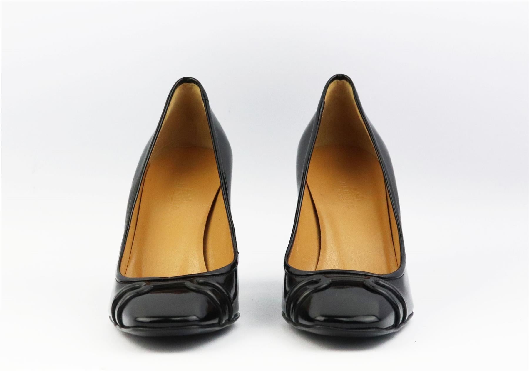 These pumps by Hermès are a classic style that will never date, made in Italy from supple black patent-leather, they have a square toe and embossed buckle detail to take you from morning meetings to dinner with friends. Heel measures approximately
