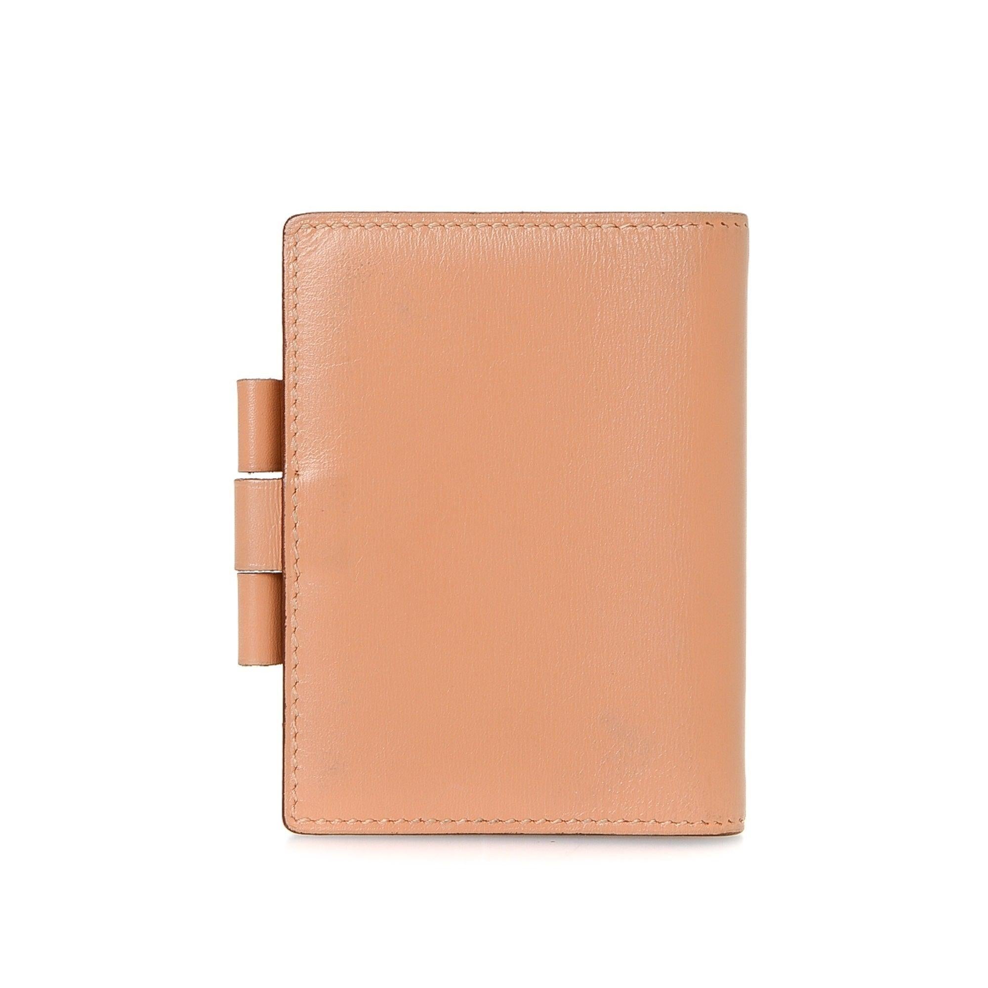 Hermes Peach Leather Mini Agenda Wallet with silver-tone hardware, leather trim, dual interior pockets, lD closure and brand stamp at interior edge.
29341MSC