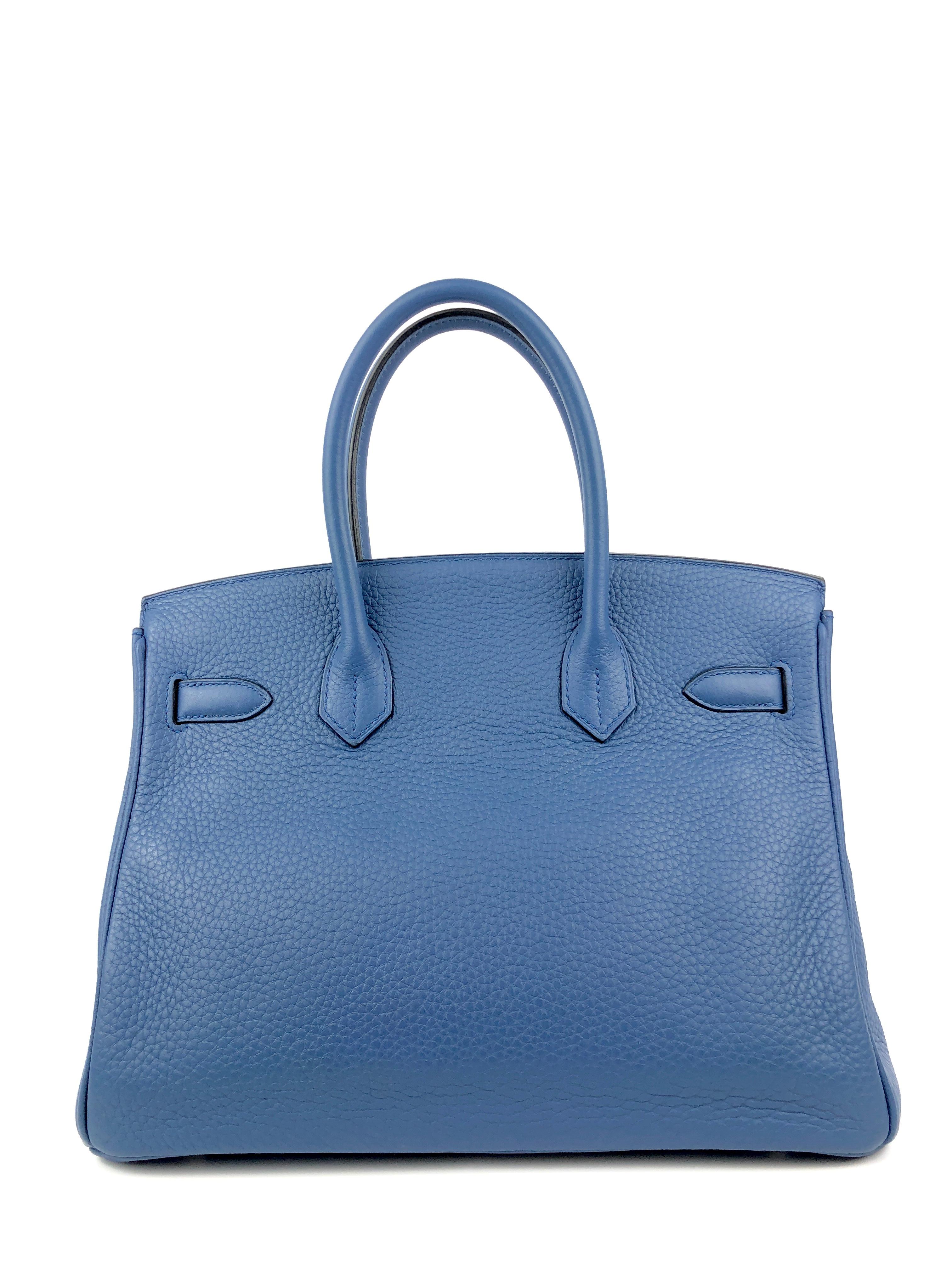 This authentic Hermès  Pebble Blue Togo 30 cm Birkin is in excellent plus condition.  A must have for blue lovers, the subtle shade is universally flattering for all year round.  
Textured and scratch resistant Togo leather is soft to the hand and