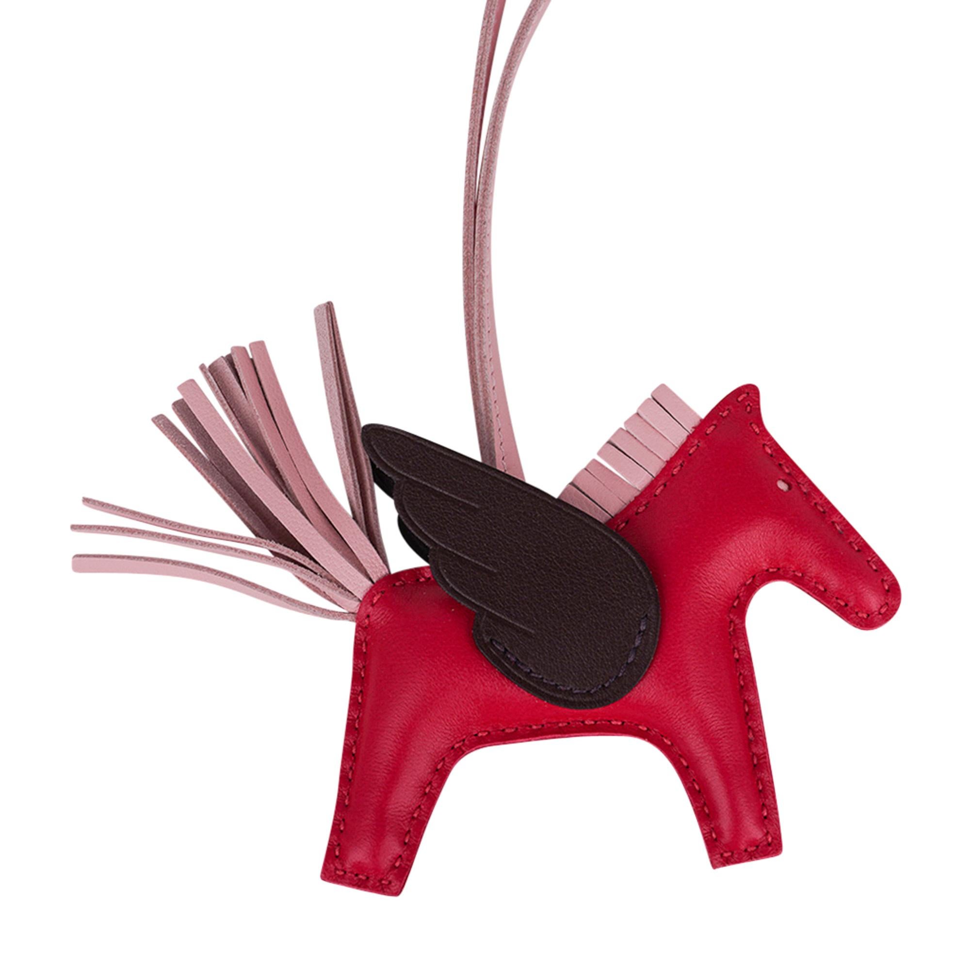 Mightychic offers an Hermes Grigri Pegase Rodeo PM featured in Framboise, Rouge Sellier and Rose Sakura.
Charming and playful she easily adorns a myriad bag colours in your fabulous collection. 
Leather is lambskin Milo.
Signature HERMES PARIS MADE