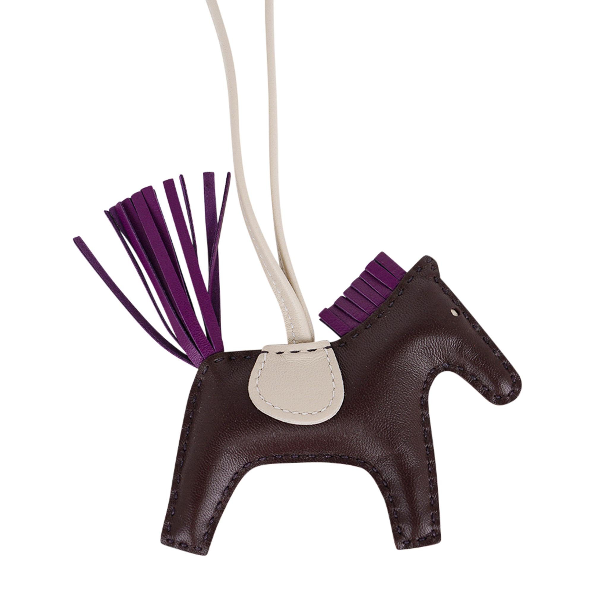 Mightychic offers a guaranteed authentic Hermes Grigri Pegase Rodeo PM featured in Rouge Sellier, Craie and Violet.
Charming and playful she easily adorns a myriad bag colours in your fabulous collection. 
Leather is lambskin Milo.
Signature HERMES