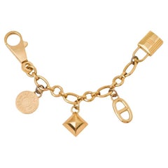 Amuleto para bolso Hermès Permabrass Olga Oro