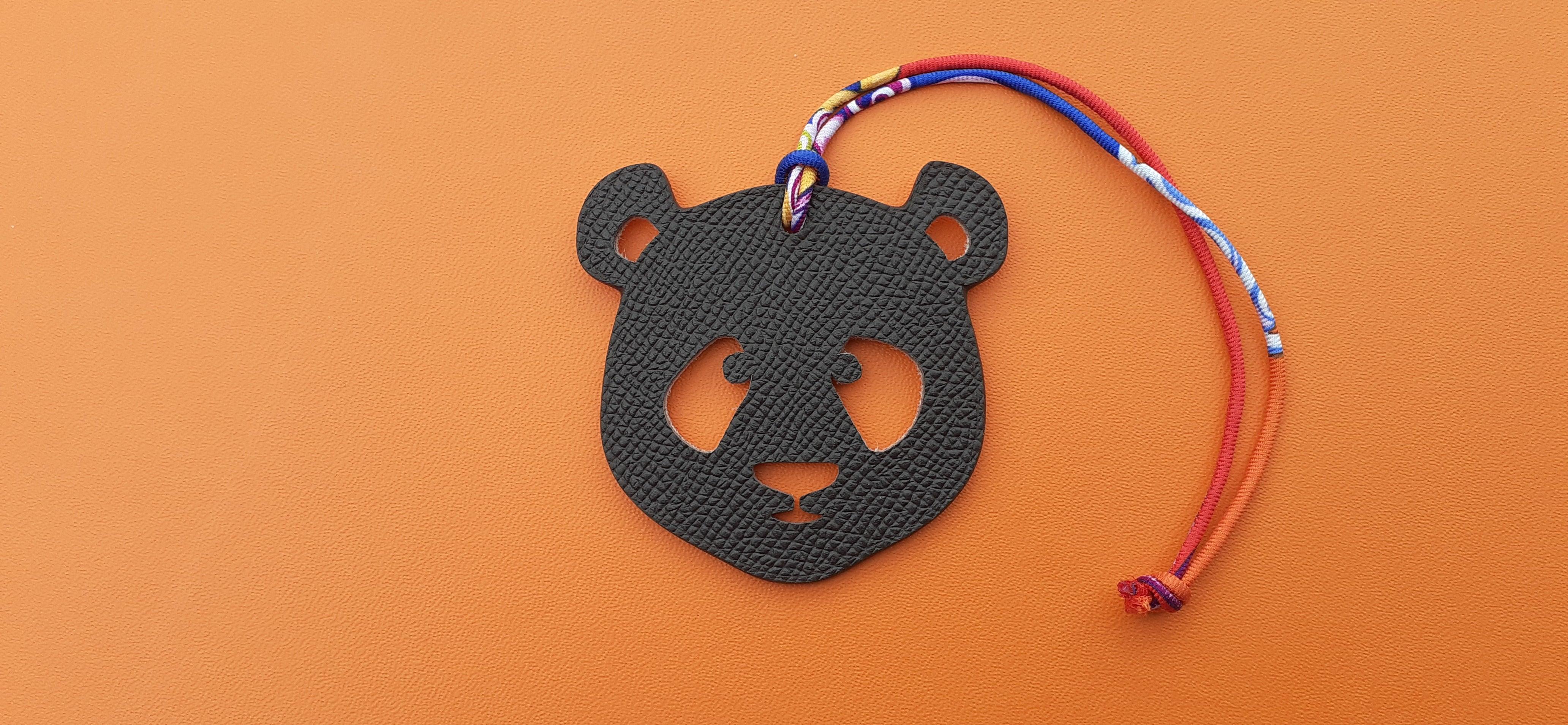 Super Cute Authentic Hermès Charm

Patter: Panda Head

Can be used as Charm for your Bag or your shoe, or as ring to tie your scarf (silk link can be removed

Made of grained leather

Colorways: Light Pink / Brown

Silk Link in red, blue, purple,