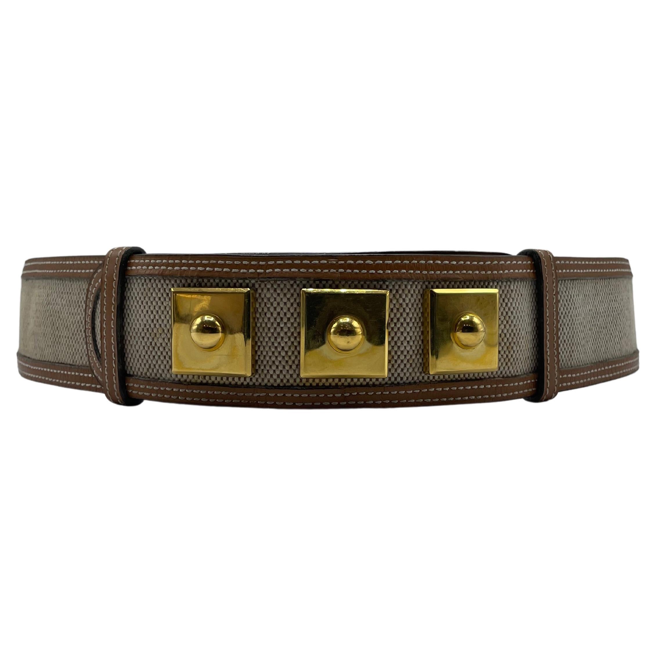 Hermès Piano Belt in Leather and Canvas. The canvas is in great shape and does not have any stains or odors. This stunning Piano belt has three gold buckles that allow for customizable sizing, and the inner is camel leather.  Made in 1946.