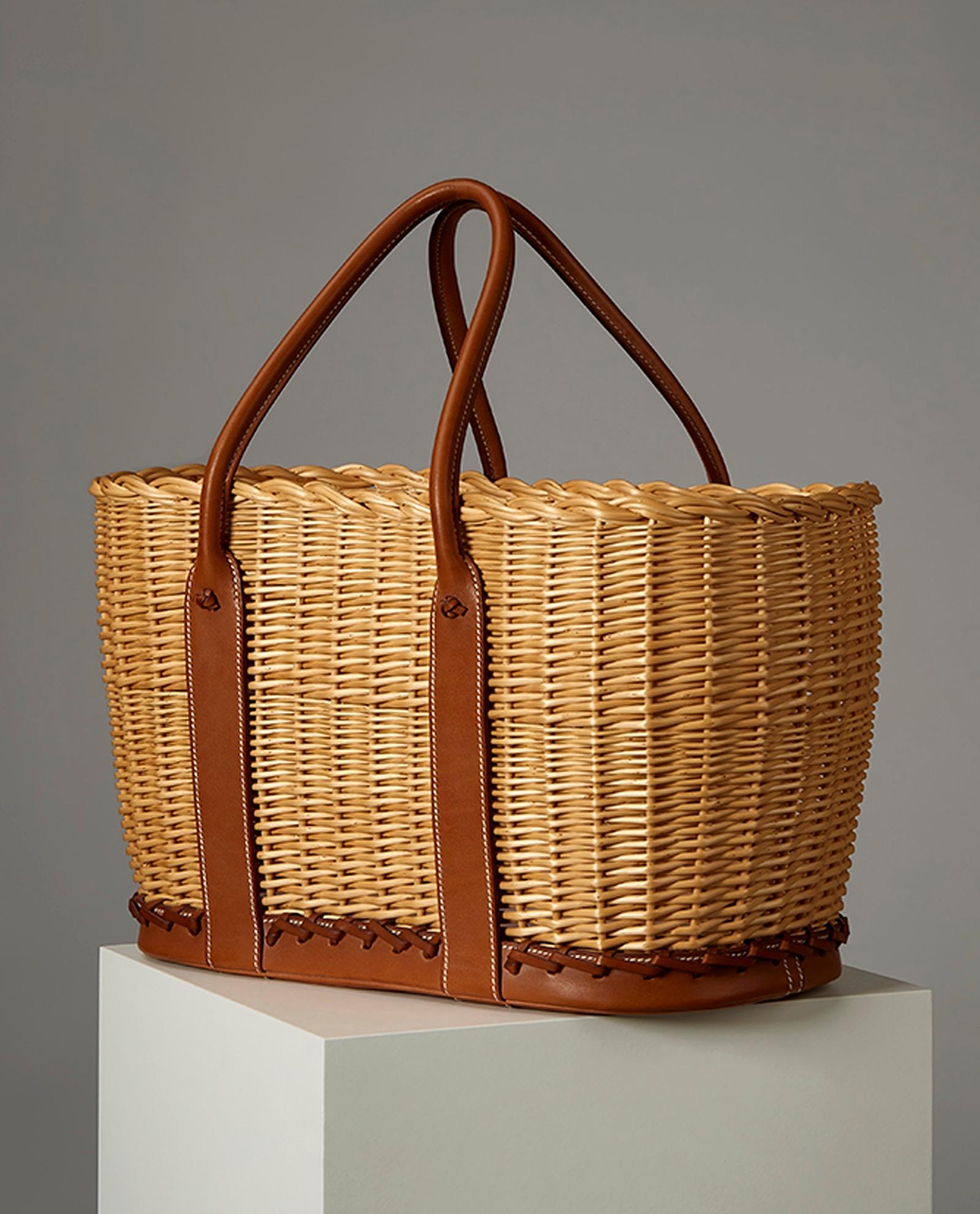 Hermes picnic basket barenia osier bag . 
Crafted from a combination of Osier Ratan Wicker and Barenia leather, This limited edition basket features contrast white stitching throughout. The light brown color of the wicker compliments the dark brown
