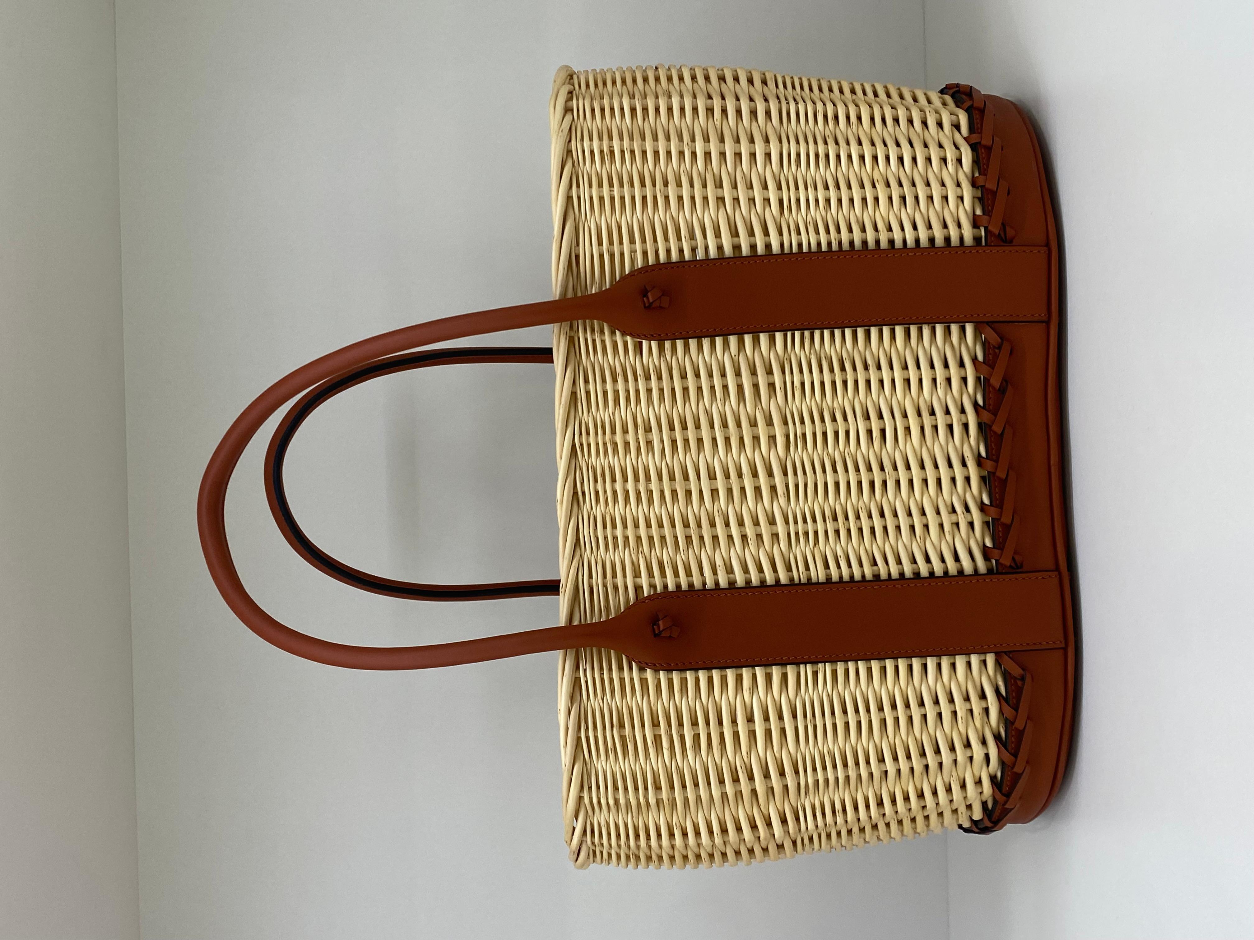Hermes picnic basket barenia osier bag . Crafted from a combination of Osier Ratan Wicker and Barenia leather, This limited edition basket features contrast white stitching throughout. The light brown color of the wicker compliments the dark brown