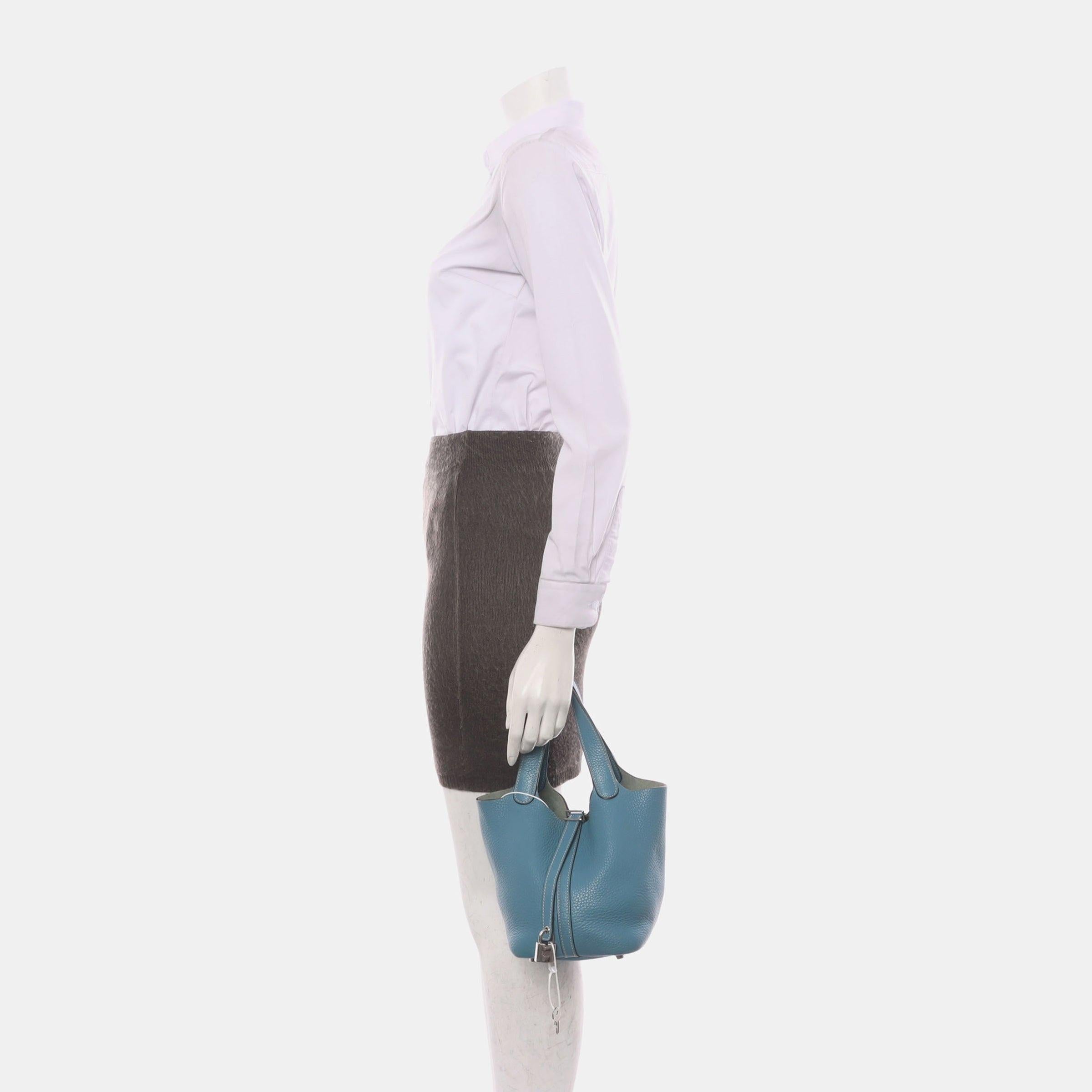 Hermes Picotin 18 Clemence Taurillon Leather Blue Jean
These are professional photos of the actual bag.
The Hermes Picotin is a nod to the equestrian world, inspired by the shape of feeder bags. This bag celebrates simplicity and serves as a