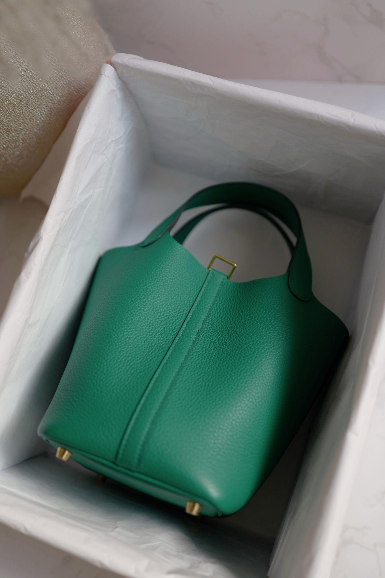 Step into timeless elegance with the Hermès Picotin 18 Vert Jade—a bag that blends simplicity with sophistication in the most effortless way. Its soft green hue captures the essence of calm luxury, while the gold hardware adds just the right touch