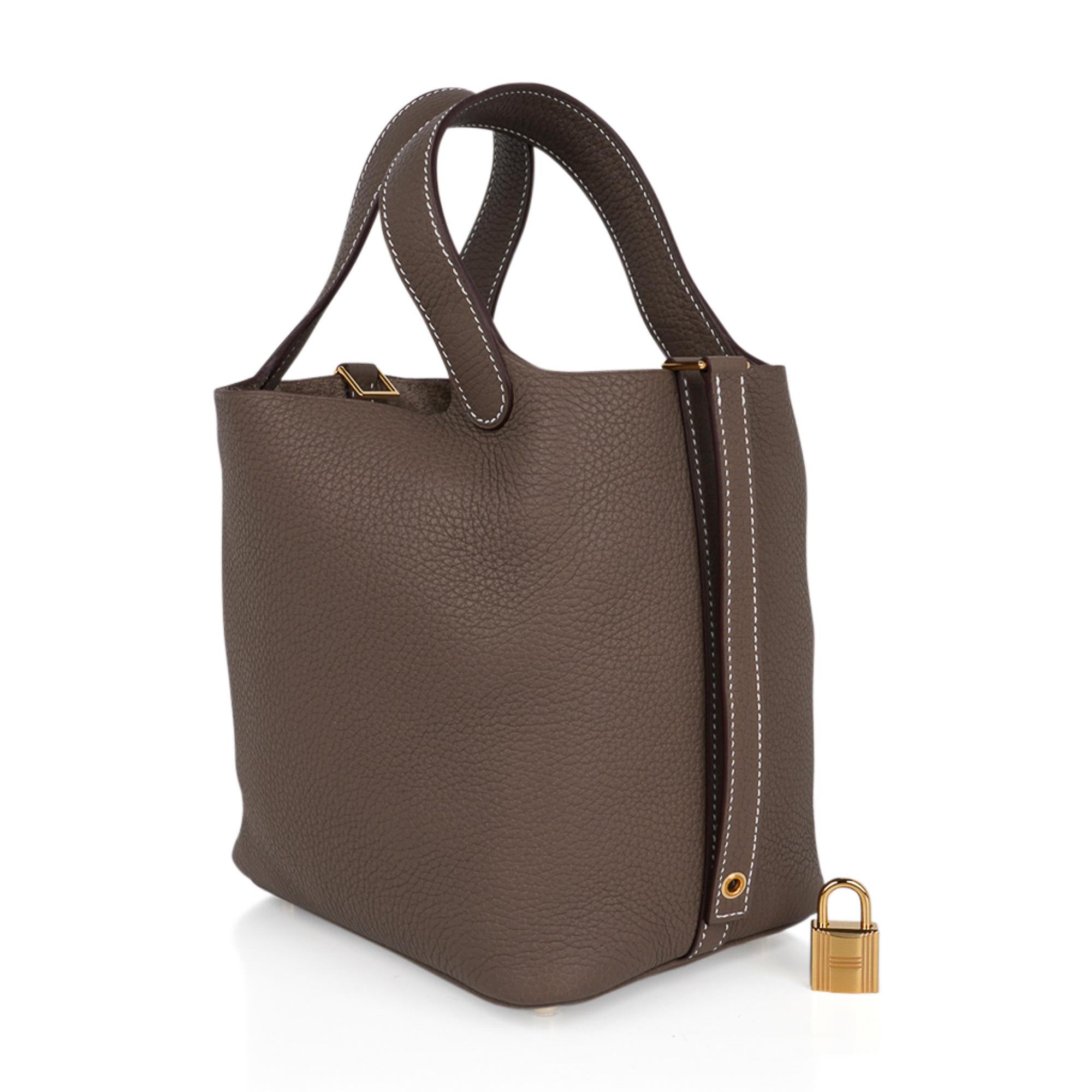 Mightychic offers an Hermes Picotin Lock 18 bag featured in featured in neutral Etoupe.
Warmed with Gold hardware.
Clemence leather.
This roomy small tote is a perfect go to bag! 
Comes with lock and keys, sleeper, and signature Hermes box.
NEW or