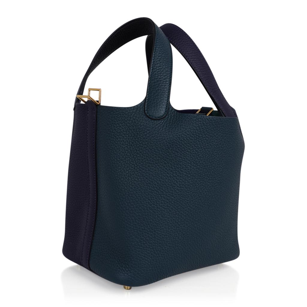 Mightychic offers an Hermes Picotin Lock 18 tote bag featured in tri colors of Vert Cypress, Blue Nuit and Black.
The body of the bag features the Vert Cypress and Bleu Nuit.
Each handle is on the two hues.
The interior of the handles are