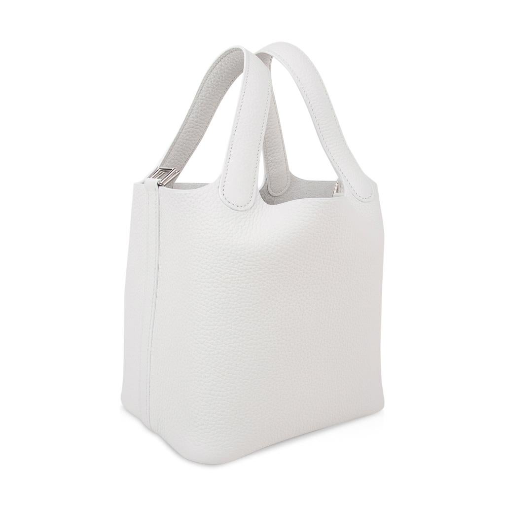 Guaranteed authentic Hermes Picotin Lock 18 tote bag features rare White.
Featured in clemence leather and with Palladium hardware.
This roomy small tote is a perfect go to bag! 
Comes with lock and keys, sleeper, and signature Hermes box.
NEW or