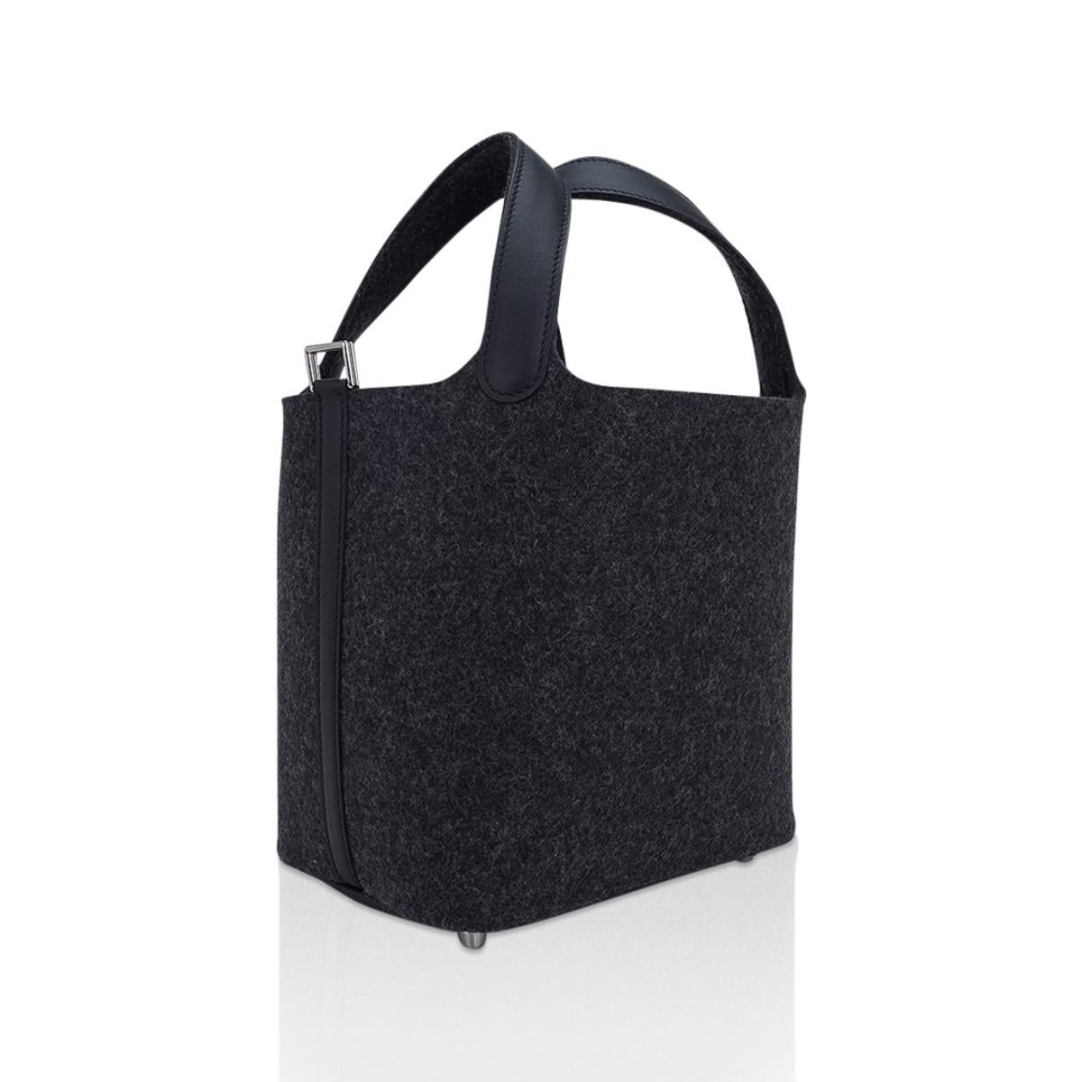 Mightychic offers a limited edition Hermes Picotin Lock Touch 18 tote bag featured in Charcoal Grey Feutre and Black Swift leather.
The handles straps are Swift. 
The body of the bag and exterior handles are Grey Feutre (Wool) with Palladium