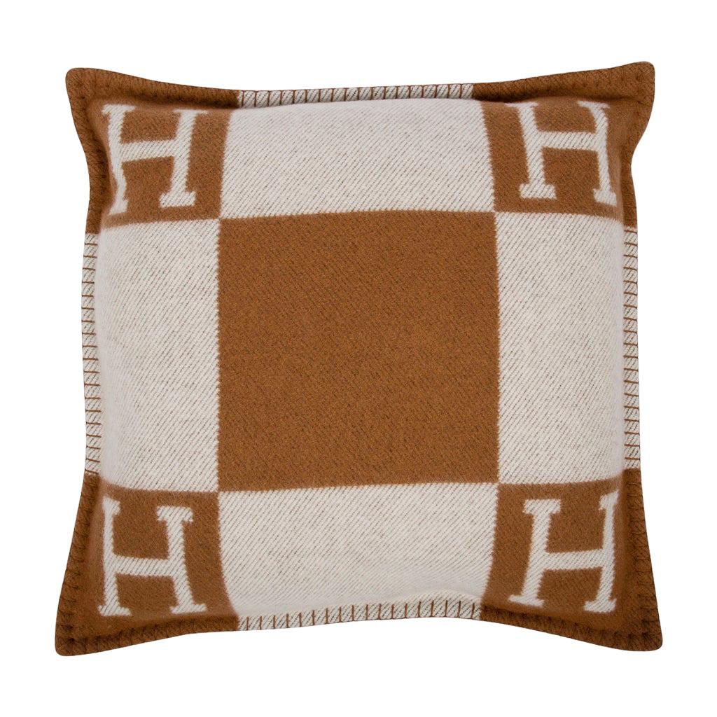 Mightychic offers a set of two (2) Hermes classic Small Model Avalon signature H pillows featured in Camel and Ecru.
The removable cover is created from 90% Wool and 10% cashmere and has whip stitch edges.
Comes with sleeper.  
Please see the