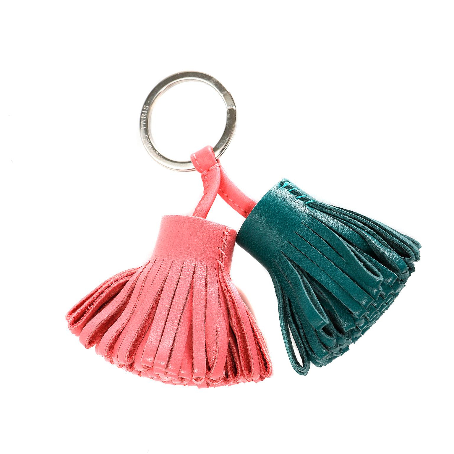 This authentic Hermès Pink and Green Leather Double Tassel Key Holder is in pristine condition.  Silver key ring holds two leather looped tassels in rose pink and dark green. 

PBF 11472