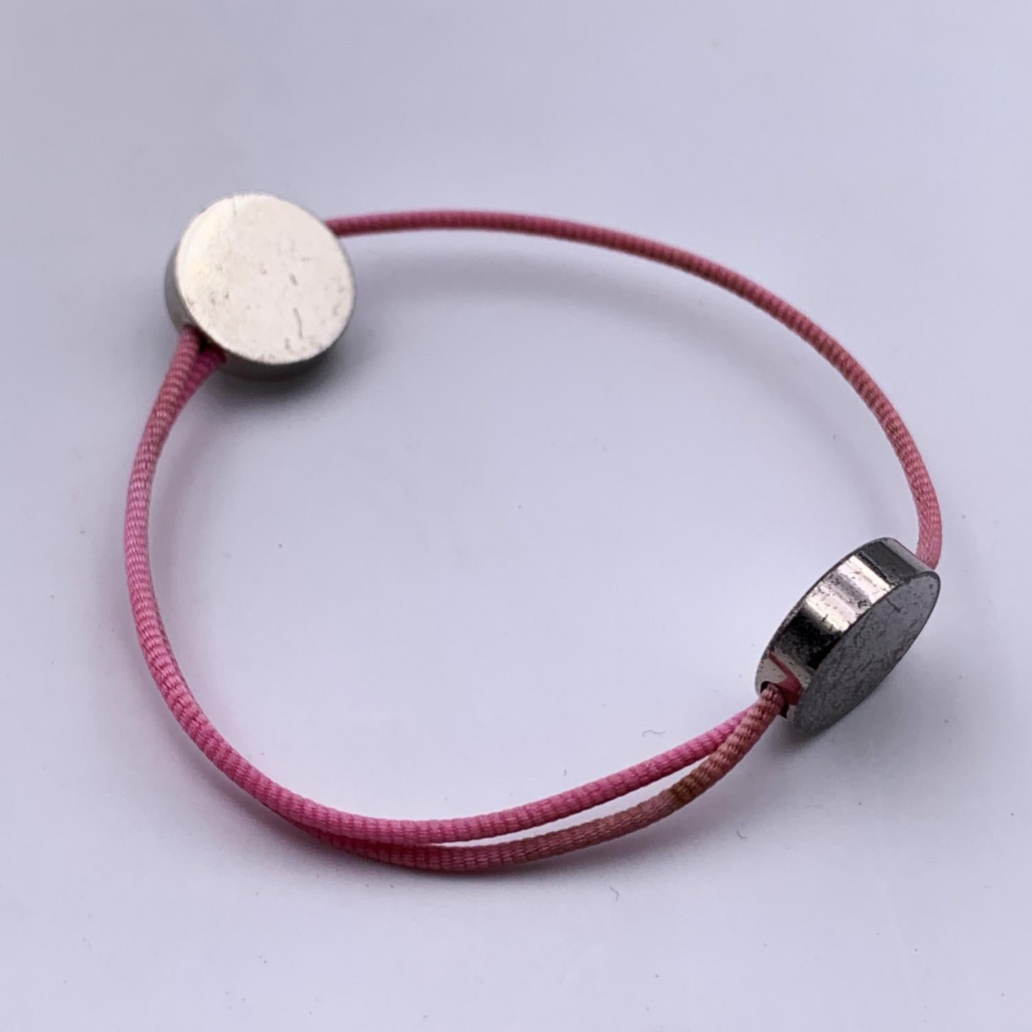 Cotton cord bracelet by HERMES in pink color. 2 silver metal studs with Hermes Paris writings. 
Condition

B - VERY GOOD

Gently used. Some darkness on silver metal elements. Please, look carefully at the photos and ask for any