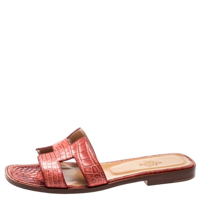 Put your best foot forward this season in these pretty Hermes sandals. These pink Oran sandals have been crafted from croc leather in Italy and they feature the iconic H on the vamps and insoles that are meant to provide comfort at every step. These