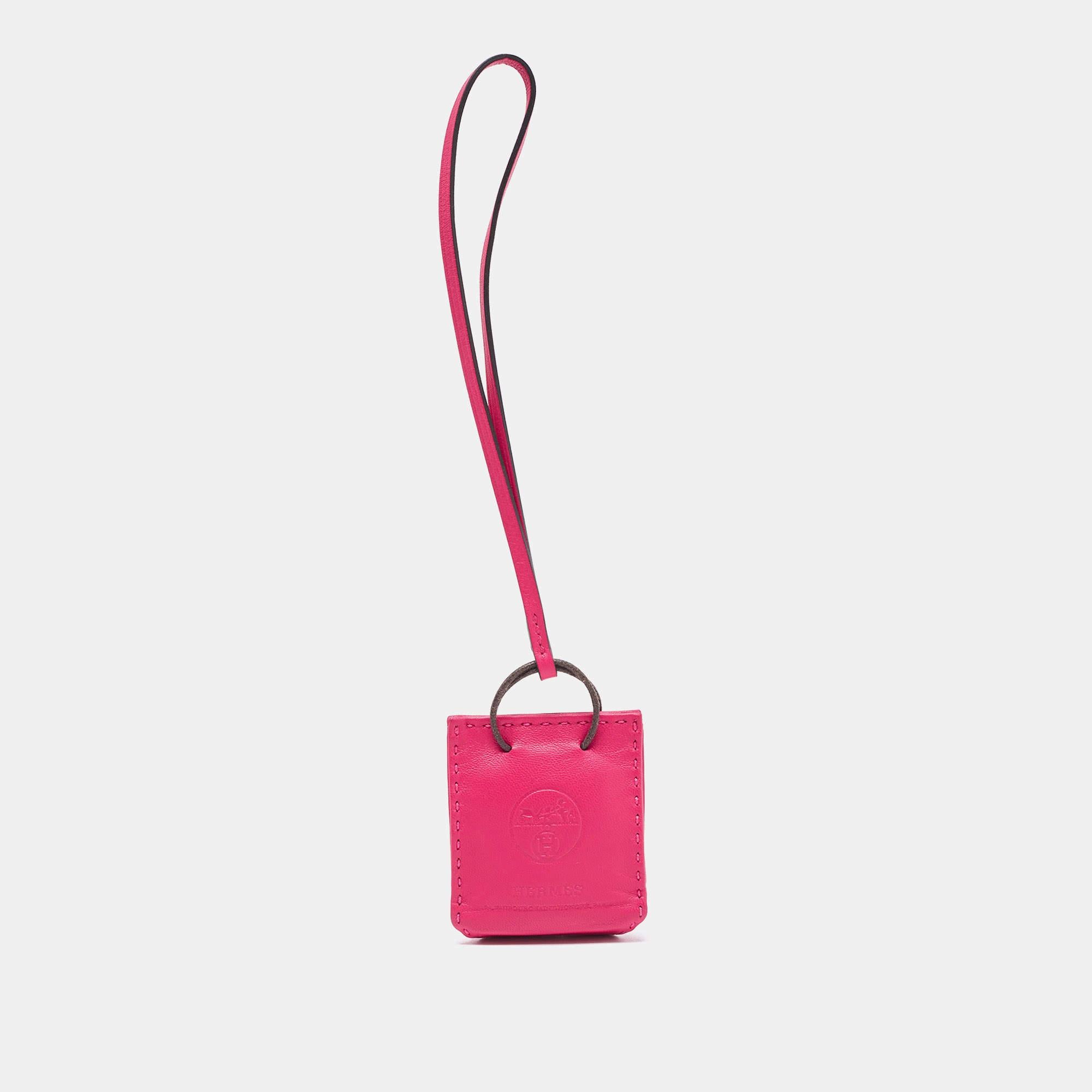 Dress up your bags with this Hermes bag charm. It is crafted using pink Milo Lambskin and Swift leather in a bag silhouette. It'll add a nice pop of color!

Includes:  Original Box, Info Booklet, Brand tag

