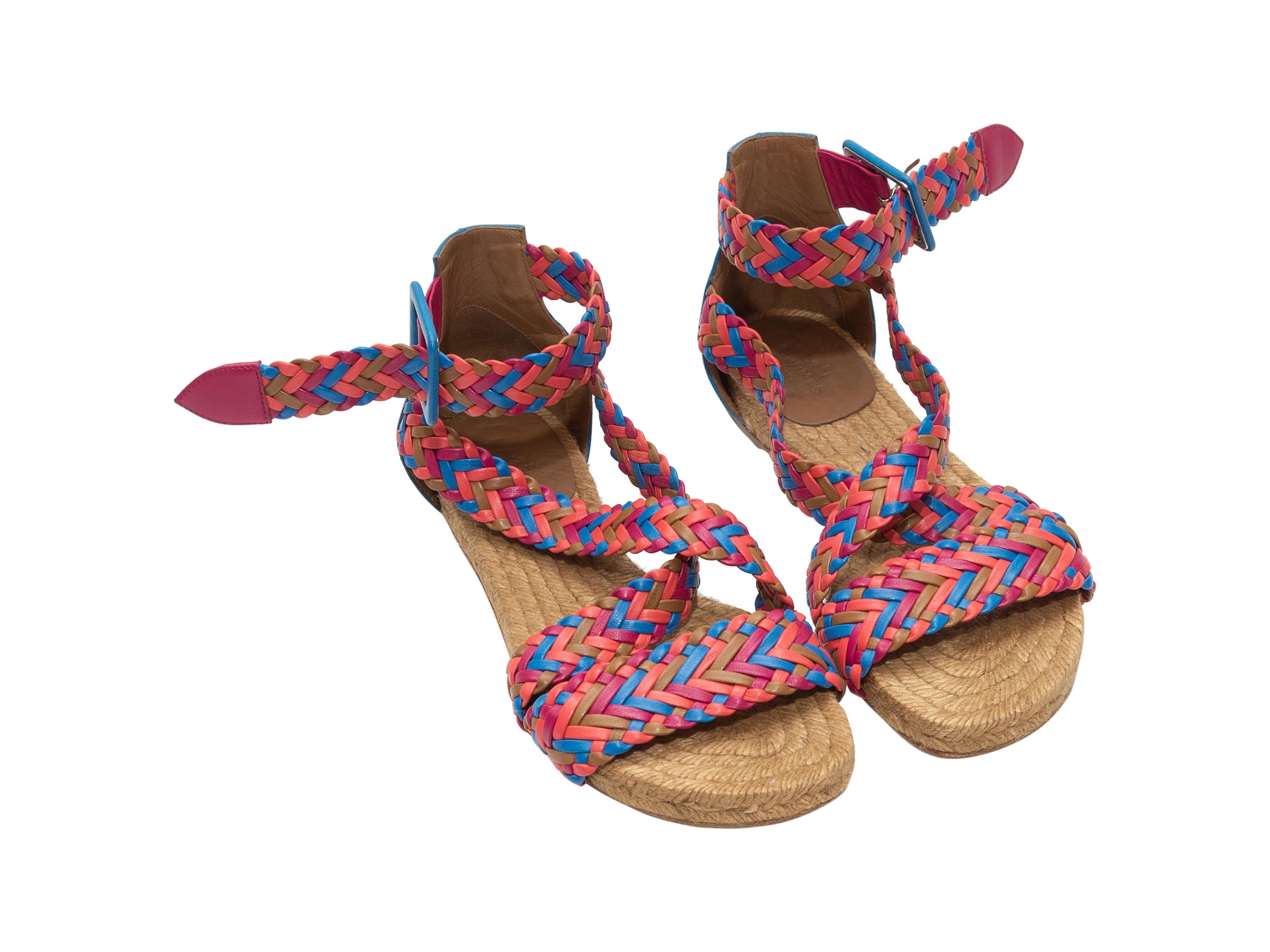 Product details: Pink, blue, orange, and tan woven leather espadrille sandals by  Hermes. Raffia and leather soles. Buckle closures at ankle straps. Designer size 35. 
Condition: Pre-owned. Good. Scuffing and water stains at outer soles.