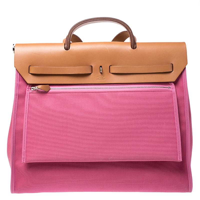 Made from pink canvas and tan leather, the Herbag Zip is just as outstanding as all of Hermes' other handbags. First introduced in 2009 as a new version of the Herbag, this piece comes with a single handle, a long shoulder strap and it flaunts