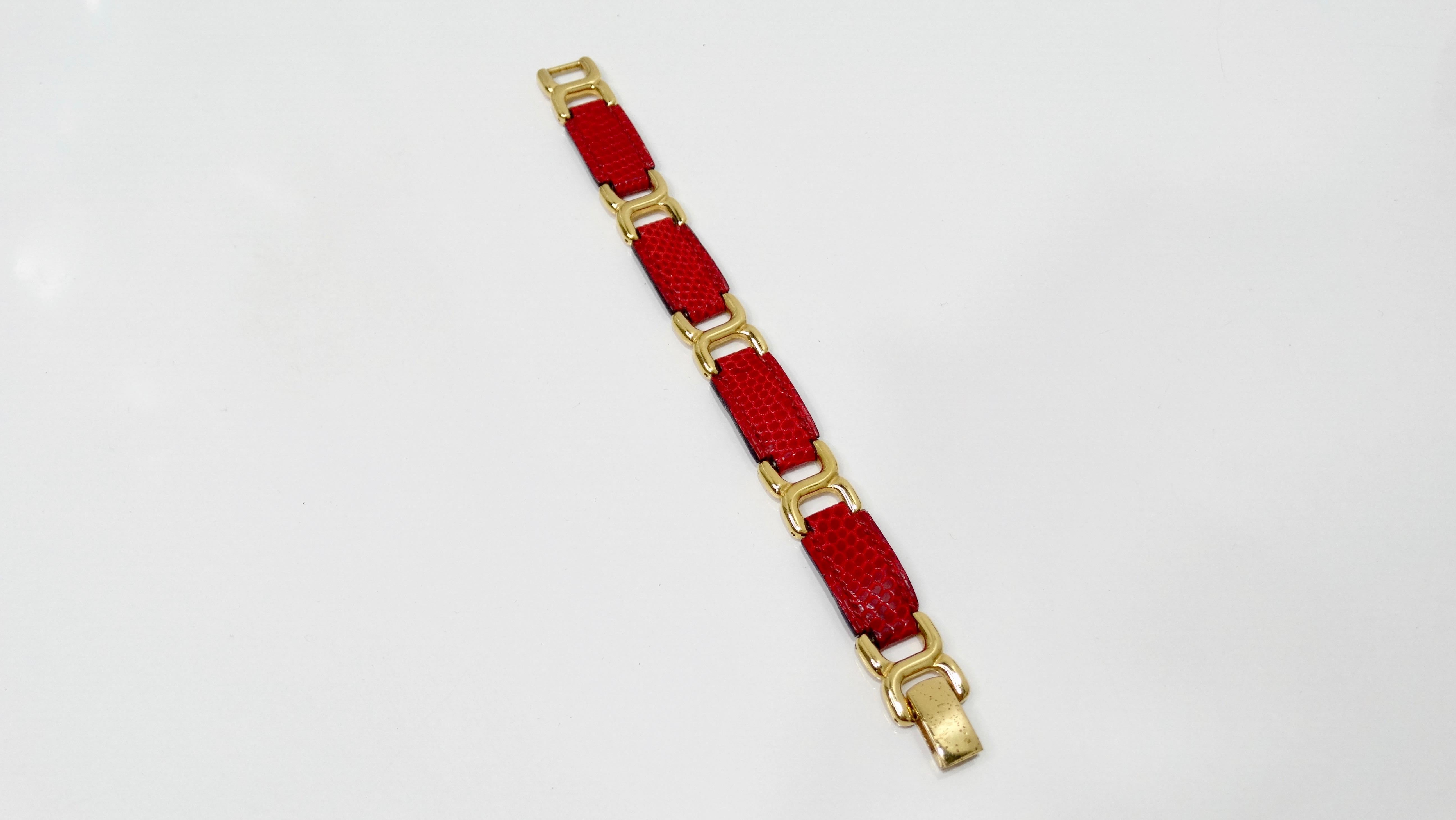 Elevate your bracelet collection with this Hermés Place Beauvau bracelet! Circa 21st century, this bracelet is plated in 18k gold and is crafted from lipstick red lizard skin. Features stirrup style links and a fold over closure. Bracelet is signed