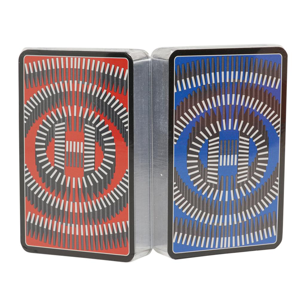 Guaranteed authentic Hermes playing cards features a limited edition rear design bridge set. 
A marvelous gifting idea!
One set is red and the other is blue. 
Trim color is silver.
The cards are new and sealed. 
Comes with signature Hermes box.
New