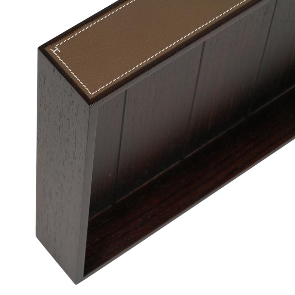 Mightychic offers a guaranteed authentic A4 Hermes Pleiade Mail Tray featured in solid mahogany wood.
Etoupe Taurillon leather with signature bone topstitch along the sides of the tray.
Small 