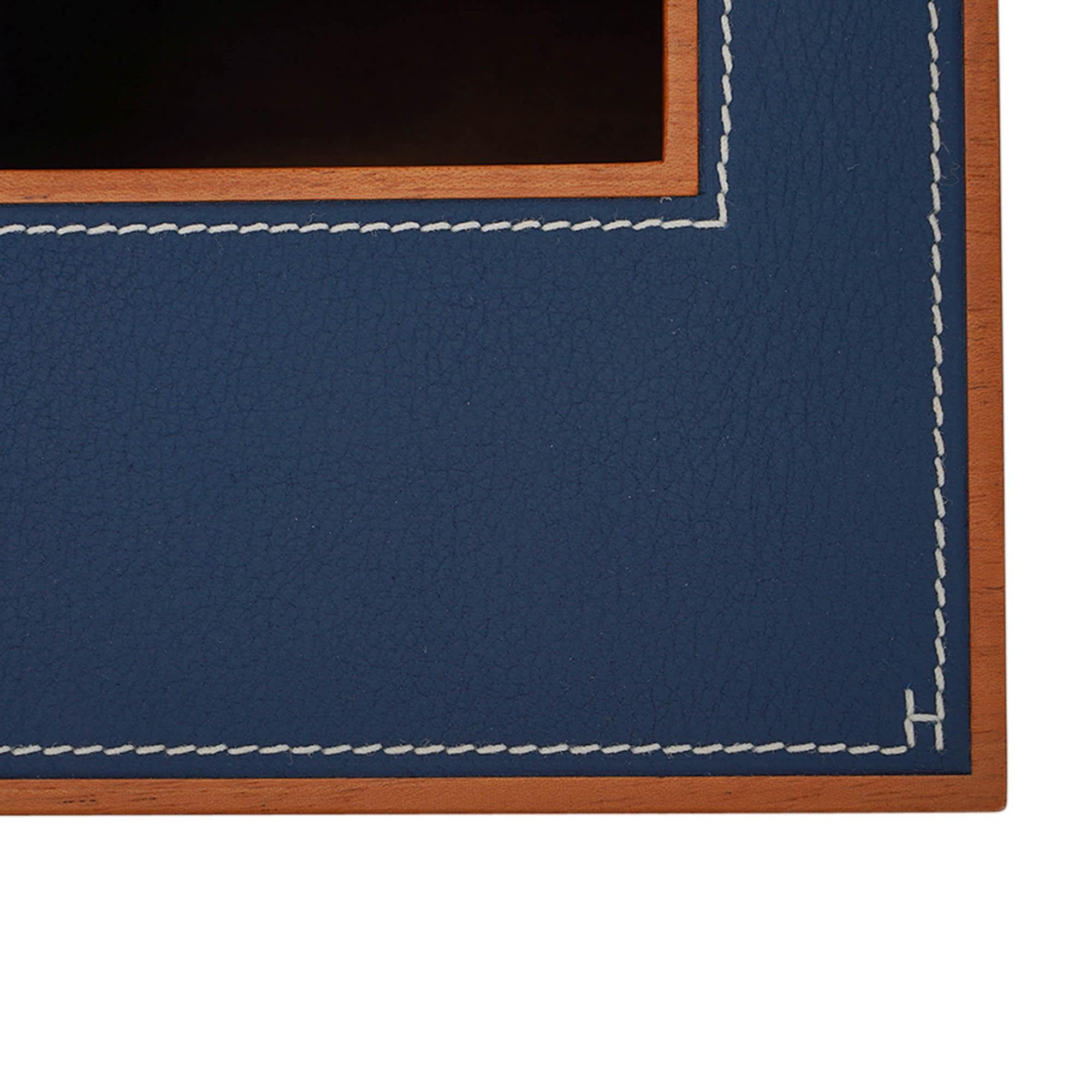 Mightychic offers an Hermes Pleiade Square Tissue Box featured in Mahogany and Bleu Regate Taurillon leather.
Modern and elegant with white topstitch on the leather.
Each box is signed with a H in a corner in white thread.
Comes with signature