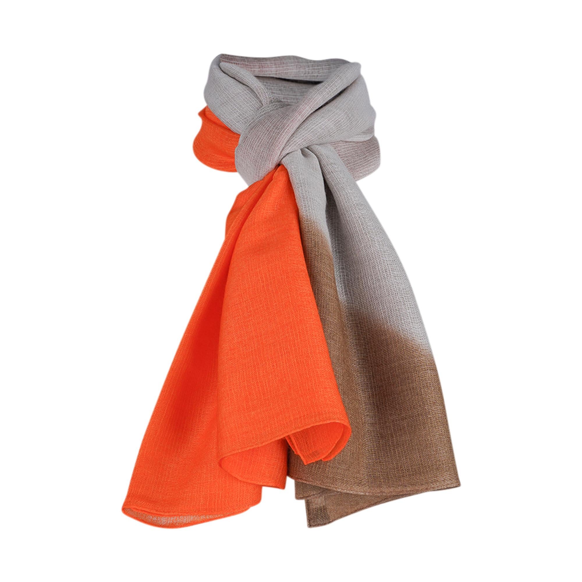 Mightychic offers a very rare Hermes Maxi Plume Cashmere and Silk wrap / shawl.
Featured in beautiful ombre moving from Orange to Beige and Bronze.
Light as a feather with subtle H Hermes Paris on one corner.
This exquisite light shawl is so fine
