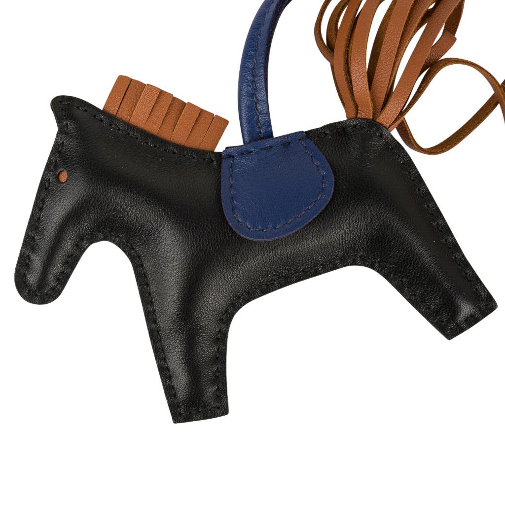Guaranteed authentic coveted Hermes PM Rodeo bag charm in Black, Blue Sapphire and Gold.
Charming and playful she easily adorns a myriad bag colors in your fabulous collection. 
Skin is Milo lambskin.
Signature HERMES PARIS MADE IN FRANCE is stamped