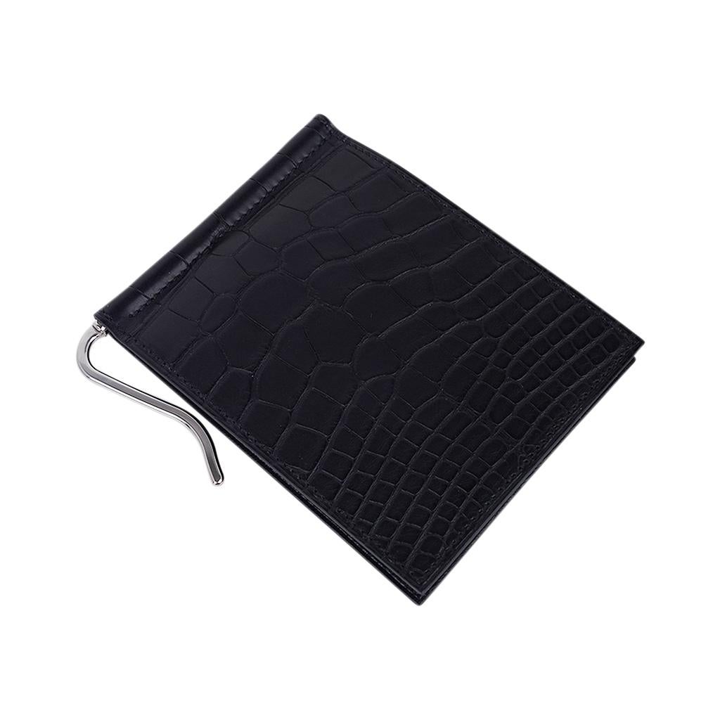 Mightychic offers an Guaranteed authentic Hermes Poker Compact Wallet featured in Black Matte Alligator.
Wallet has 6 credit card slots and palladium plated bill clip.
Sleek clean lines.
HERMES Paris Made in France on interior flap.
Comes with
