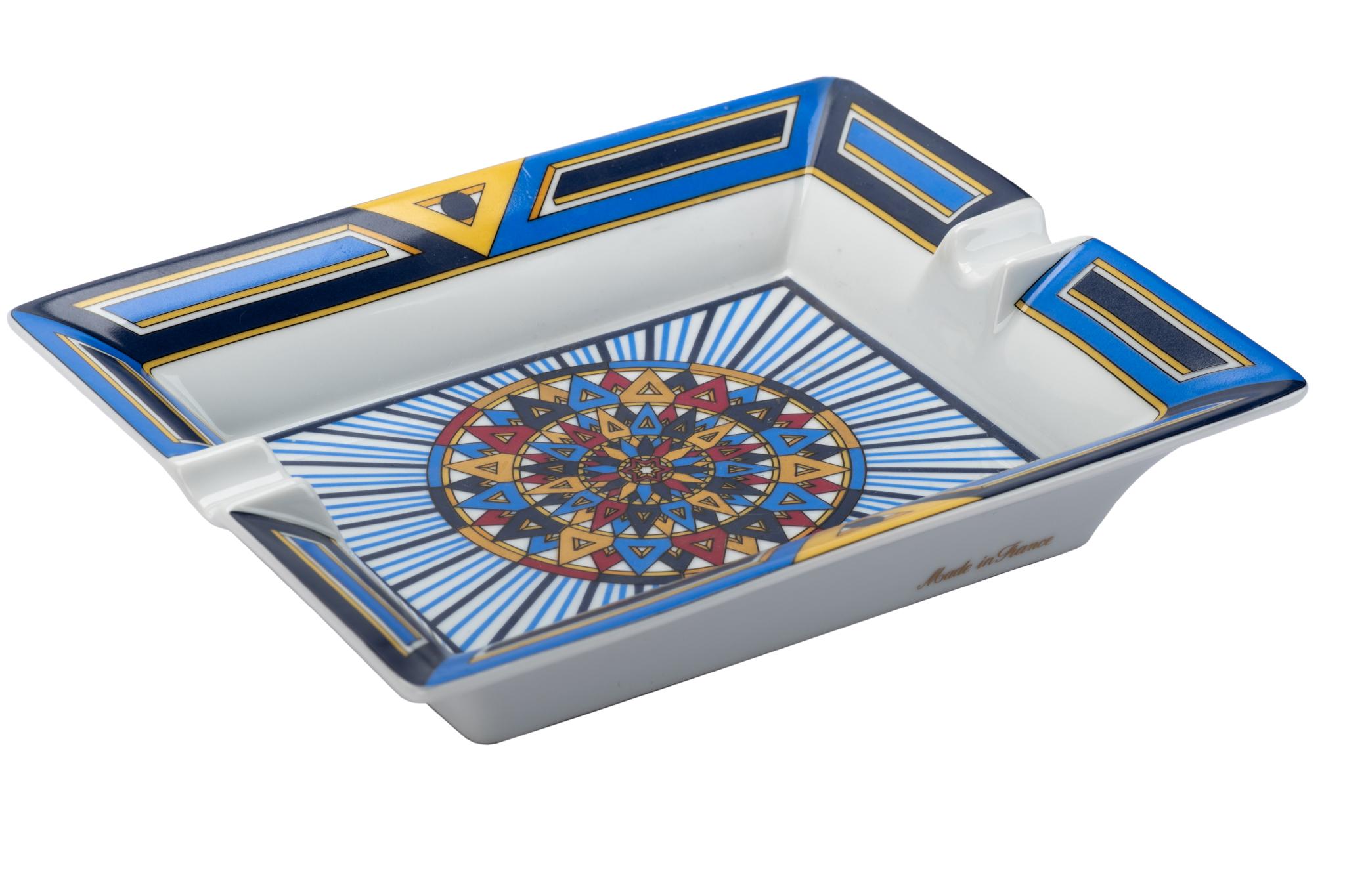 Hermès signature ashtray with geometric design in blue, white and gold. Suede stamped underneath. Made in France. Excellent condition.