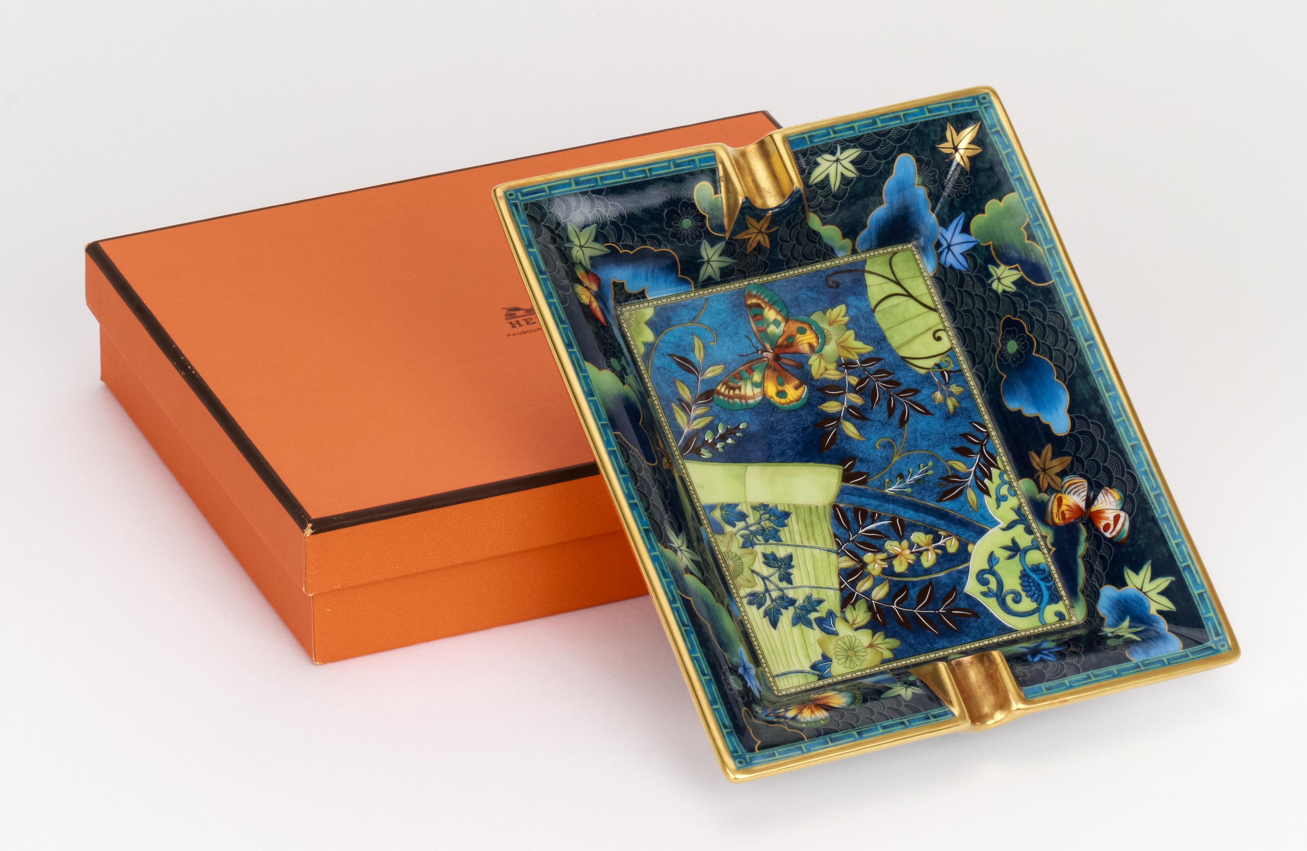 Hermès blue and green porcelain ashtray with butterfly design. Mint condition. Comes with original box.
