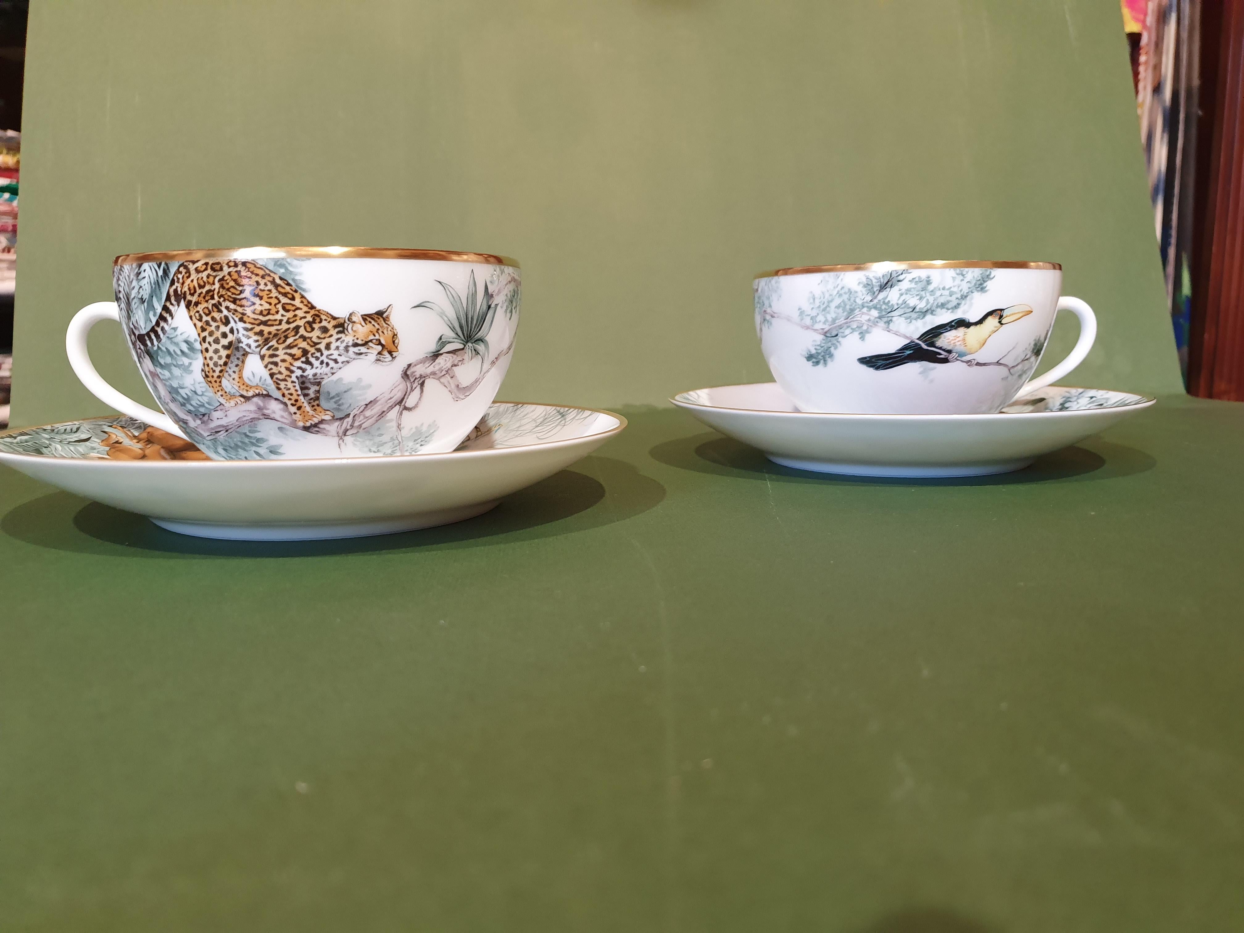 A set of two breakfast cups and saucers.
Hermès Carnets d' Equateur: jaguars, macaws, panthers and impalas frolic through lush natural settings under the watchful eye of naturalist and painter Robert Dallet. This porcelain collection breathes new