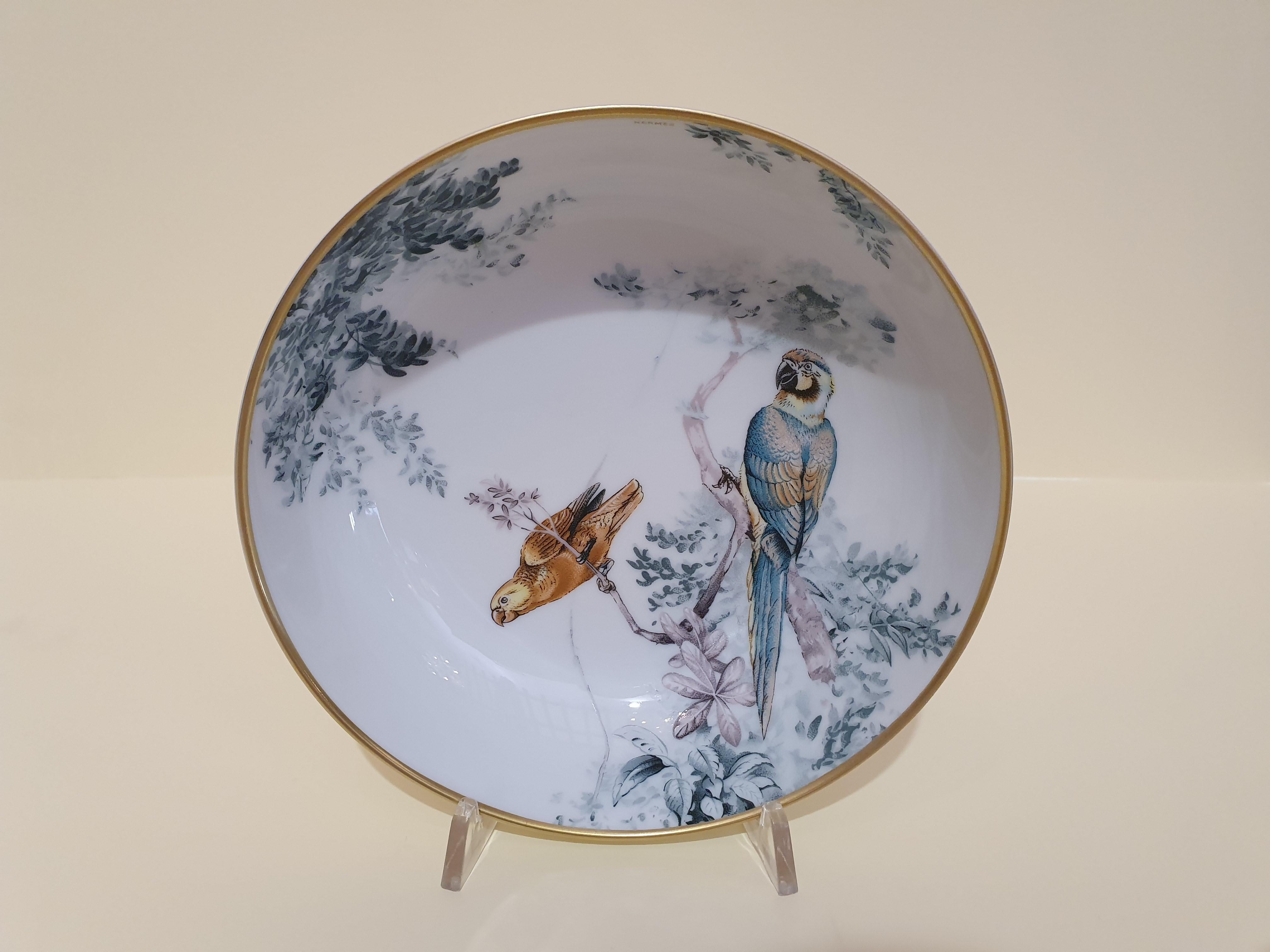 A set of two cereal bowls.
Hermès Carnets d' Equateur: jaguars, macaws, panthers and impalas frolic through lush natural settings under the watchful eye of naturalist and painter Robert Dallet. This porcelain collection breathes new life into the