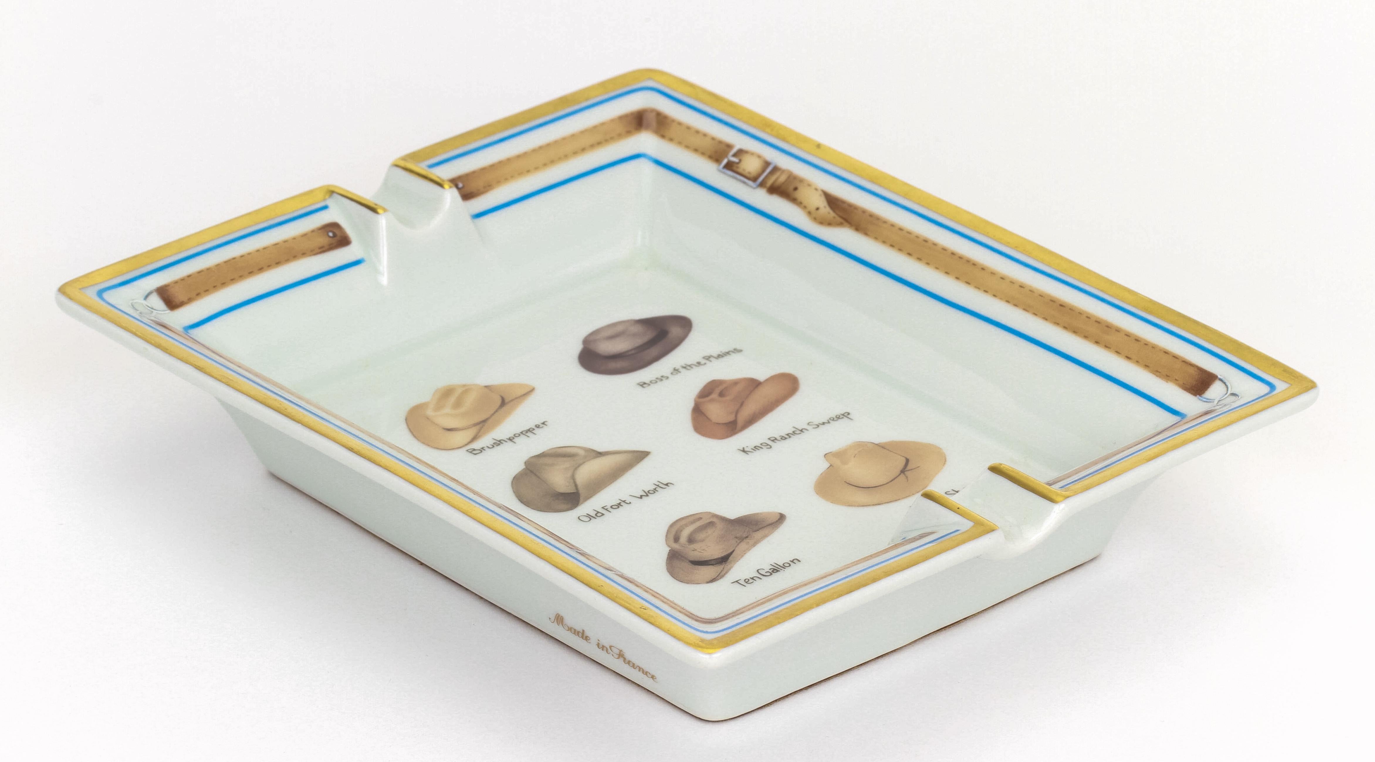 Hermès white and blue porcelain ashtray with cowboy hats design. Excellent condition.
