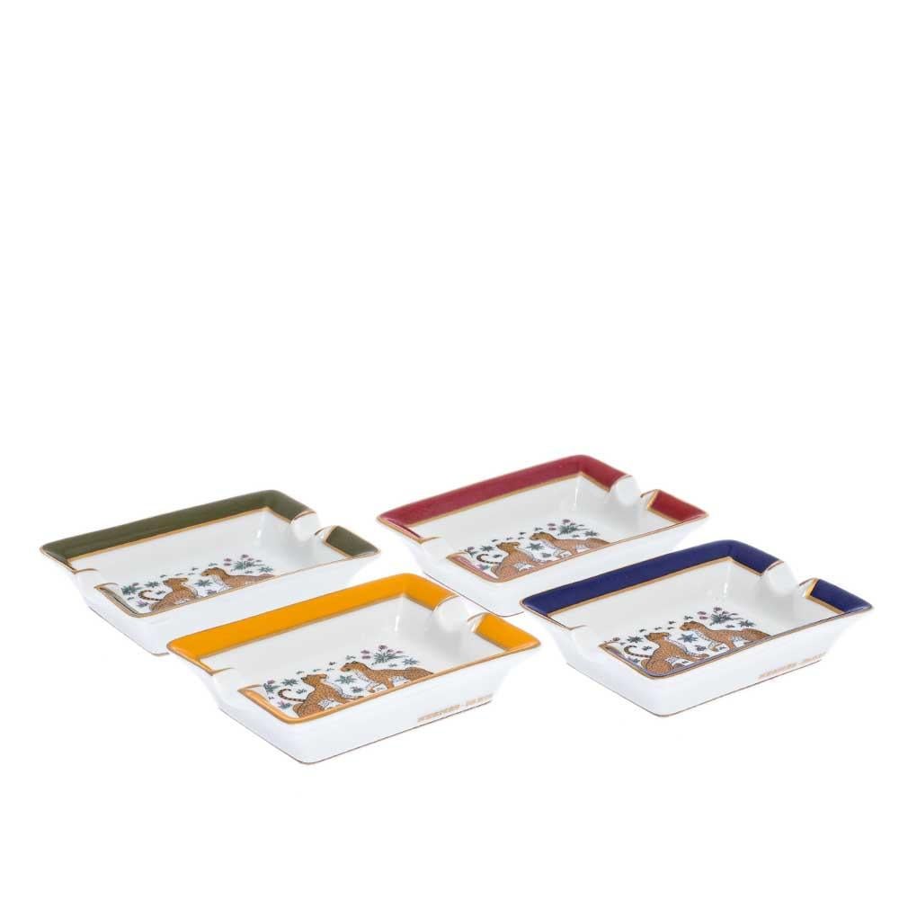 Introduce luxury and artistry to your tabletop with this set of four ashtrays from Hermes. Beautiful and elegant, they are made from quality porcelain and decorated with lovely motifs in rich hues. A durable and protective base completes this