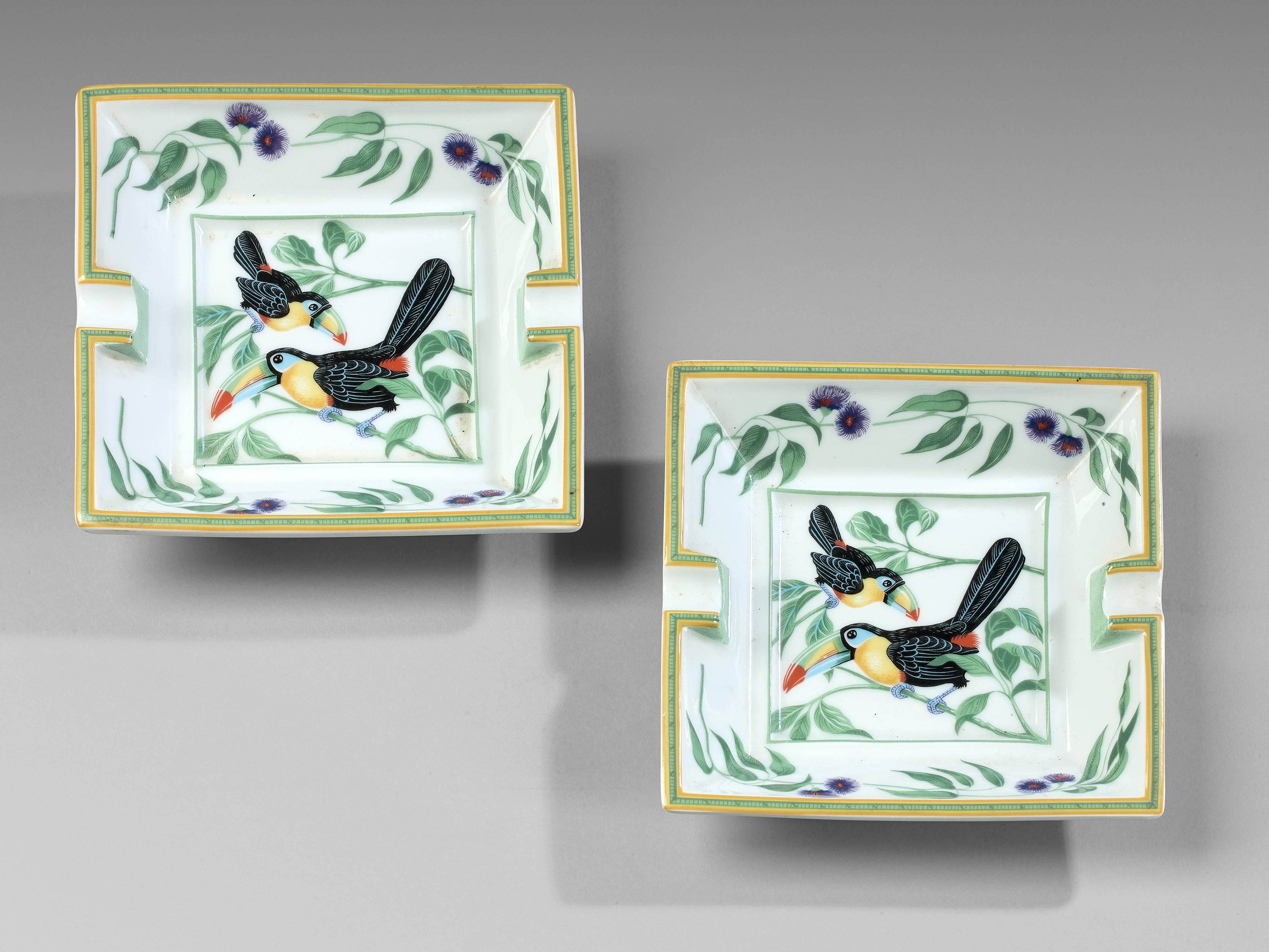 An oblong white porcelain cigar ashtray of typical style with decoration to the centre of Toucan.
Marked HERMES PARIS to one side and MADE IN PARIS to the opposite, the base, suede covered.