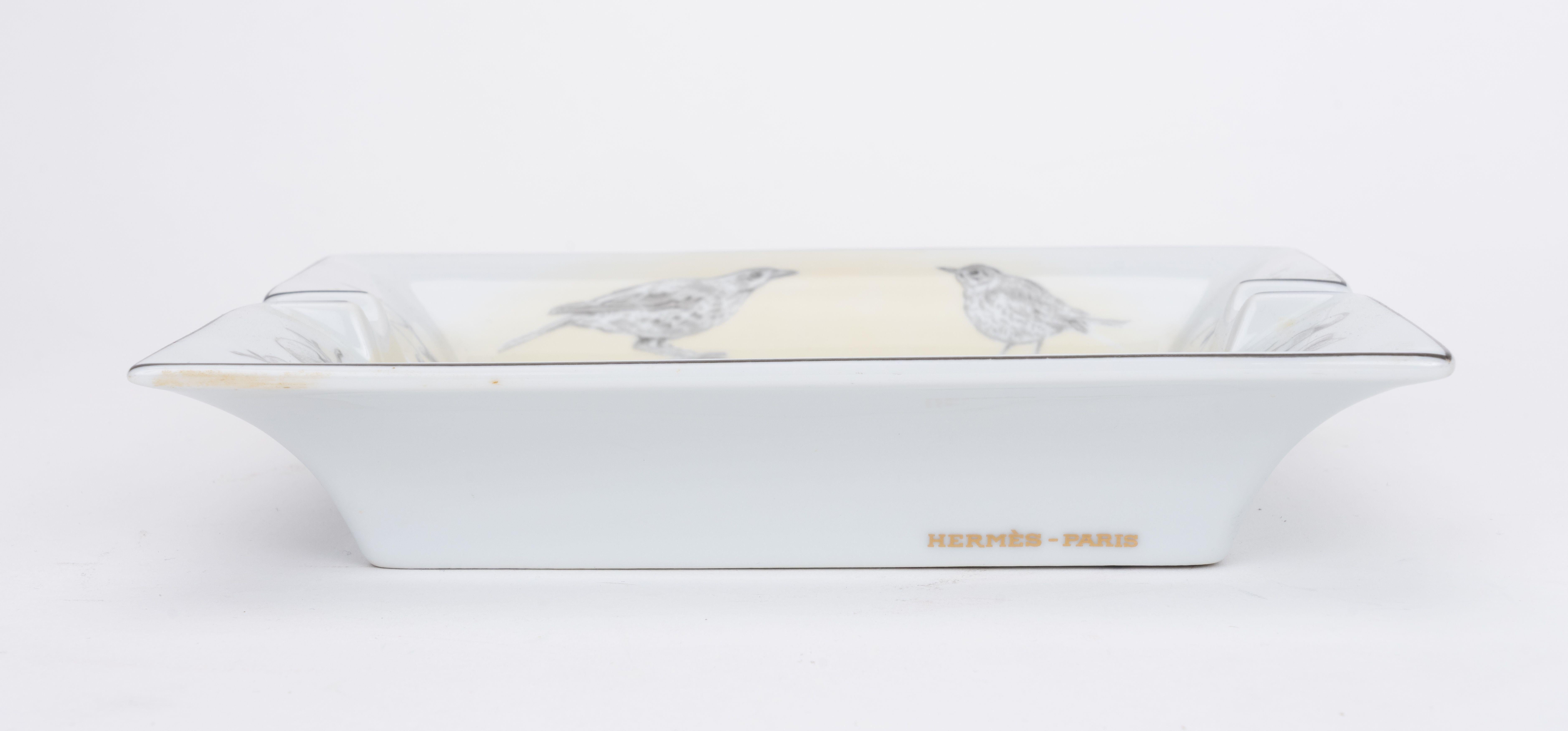Hermès grey and white porcelain ashtray with wild birds design. Minor wear on back suede.