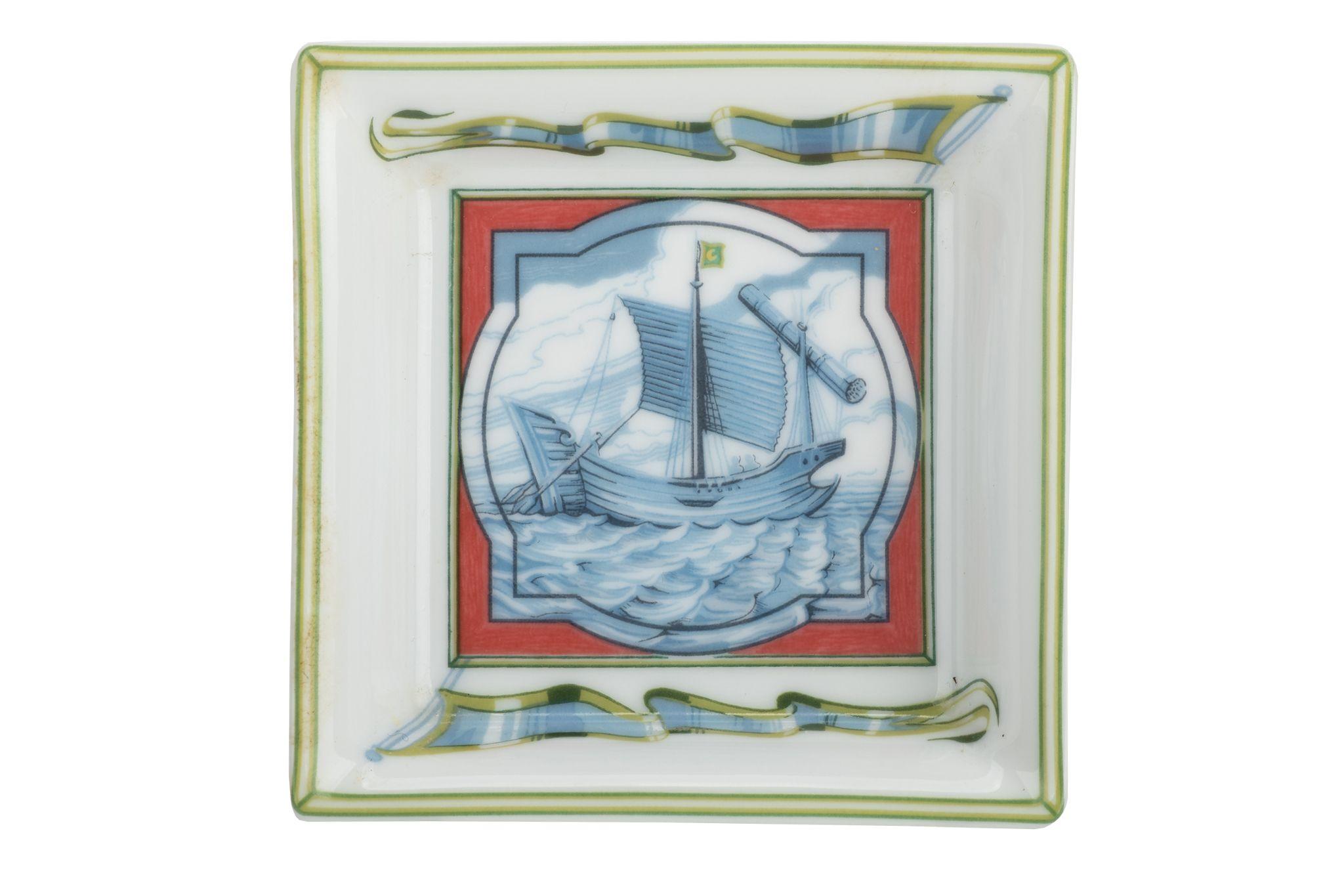 Hermès blue and white ashtray. The tray is painted with a sailing ship in the middle and is square. It is in excellent condition.