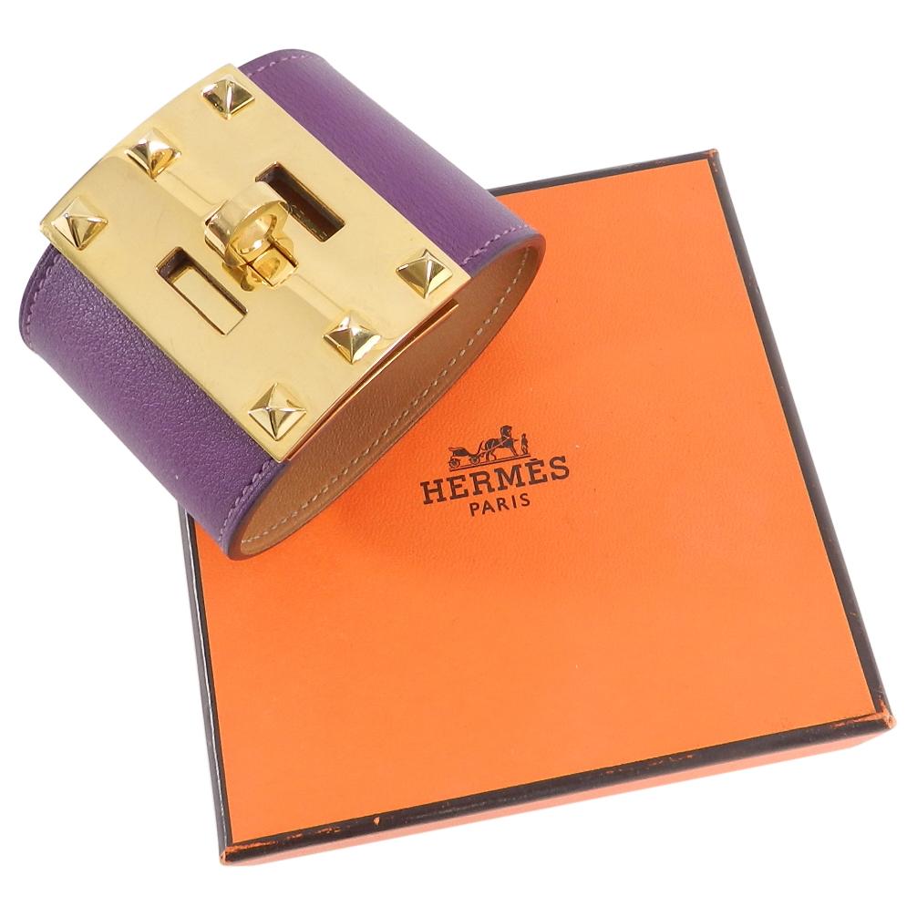 Hermes Kelly Dog Extreme Cuff Bracelet.  Smooth swift leather in anemone purple.  Gold turn clasp plated closure with pyramid studs.  Excellent pre-owned condition with some light scratching to metal.  Includes brown velvet pouch and box. Date stamp
